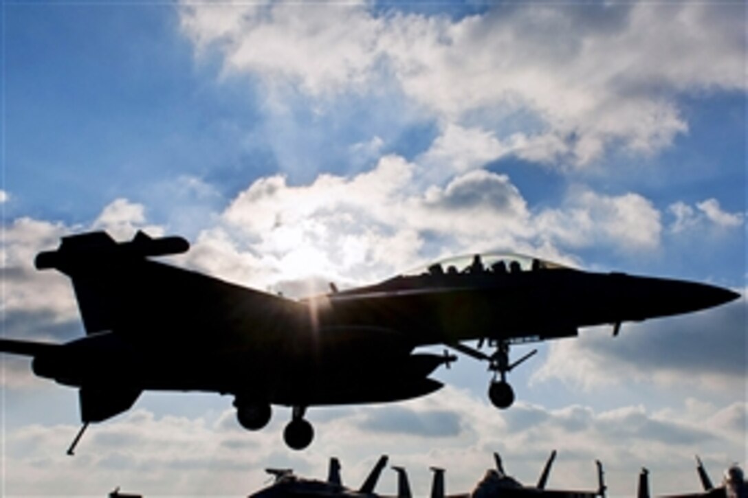 An EA-18G Growler lands on the flight deck of the aircraft carrier USS Harry S. Truman in the Arabian Gulf, Jan. 13, 2014. The Harry S. Truman, flagship for the Harry S. Truman Carrier Strike Group, is deployed to the U.S. 5th Fleet area of responsibility conducting maritime security operations and supporting theater security cooperation efforts. The Growler is assigned to the Electronic Attack Squadron 130.