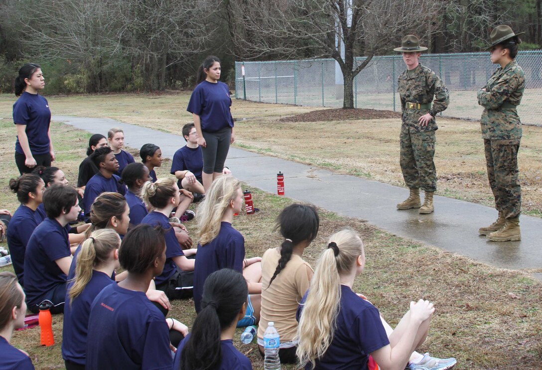 U.S. Marine Corps Sgt. Patricia A. Aliff, left, a Harrisburg, Va., native, and U.S. Marine Corps Sgt. Brenda E. Clayton, right, a Santa Barbara, Calif., native, drill instructors with P Company, 4th Recruit Training Battalion, Marine Corps Recruit Depot Parris Island, S.C., speak to female poolees, with Marine Corps Recruiting Station Raleigh, about boot camp during the all-female pool function at the Smithfield Aquatic Center in Smithfield, N.C., Jan. 11, 2014. Female poolees from across North Carolina came together to run an initial strength test, consisting of flexed-arm hang, crunches, a one and a half mile run and learn what boot camp is all about from female drill instructors from Marine Corps Recruit Depot Parris Island, S.C. (U.S. Marine Corps photo by Sgt. Dwight A. Henderson/Released) 