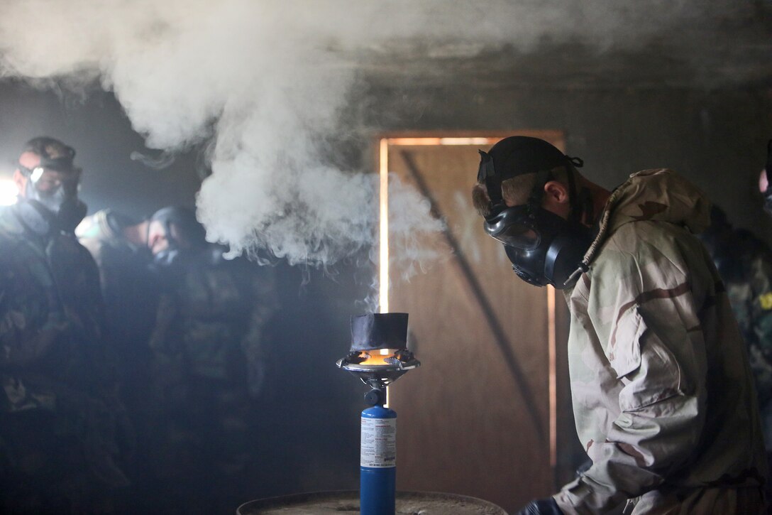 Corporal Chase Roesner, a chemical, biological, radiological and nuclear defense specialist with Combat Logistics Regiment 17, 1st Marine Logistics Group, pops a capsule of tear gas to train Marines aboard Camp Pendleton, Calif., Jan. 7, 2014, against potential CBRN threats. Marines received training on conducting reconnaissance and identifying potential CBRN threats, operating equipment designed to protect personnel from chemical threats and decontamination procedures ensure Marines do not become casualties. 