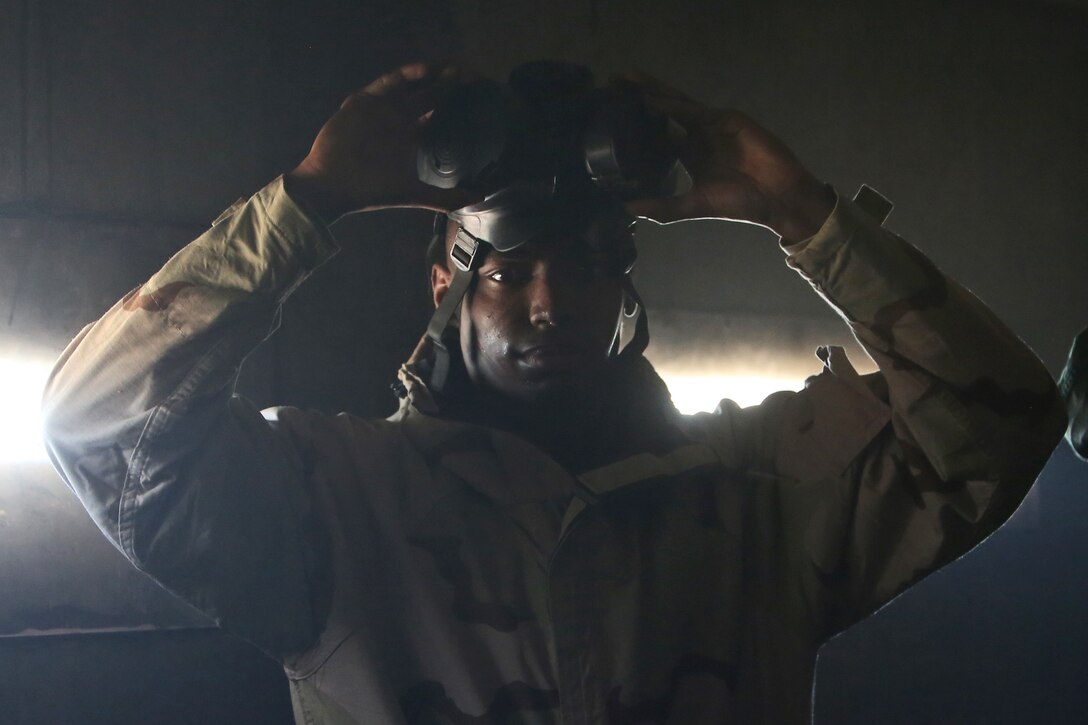Corporal Cavin S. Sanders, a chemical, biological, radiological and nuclear defense specialist with Headquarters Company, Combat Logistics Regiment 17, 1st Marine Logistics Group, breaks the seal on his M50 gas mask as part of a course designed to instruct Marines on how to defend against CBRN threats aboard Camp Pendleton, Calif., Jan. 6, 2014 Marines received training on conducting reconnaissance and identifying potential CBRN threats, operating equipment designed to protect personnel from chemical threats, and decontamination to ensure they take necessary steps to ensure Marines do not become casualties. Sanders is a native of Miami. 
