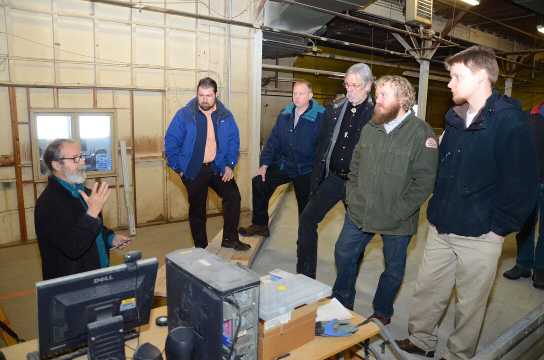 Members of the St. Paul District’s Fargo-Moorhead Metro Flood Risk Management team recently made a site visit to view a model of the Maple River aqueduct over the  proposed diversion channel. The 50:1 scale model measures 80 feet by 70 feet is being constructed at the University of Minnesota Outreach Research and Education Park in Rosemount, Minn. Here, Chris Ellis, Senior Research Associate at St. Anthony Falls Laboratory, explains to Corps employees (left to right) Kurt Heckendorf, Craig Evans, Randy Devendorf, Jon Sobiech and Bob Edstrom, how the model will collect data that engineers can use to refine how the project is designed and constructed.