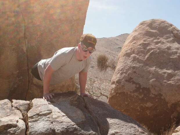 During a trip to Joshua Tree National Park in Twentynine Palms, Calif., Cpl. Mark Fidler, a wounded Marine, climbs a rock and finishes the climb with a push up. With the help of the Armed Service Blood program, Fidler has made vast strides in his recovery since his injury in October 2011. 
