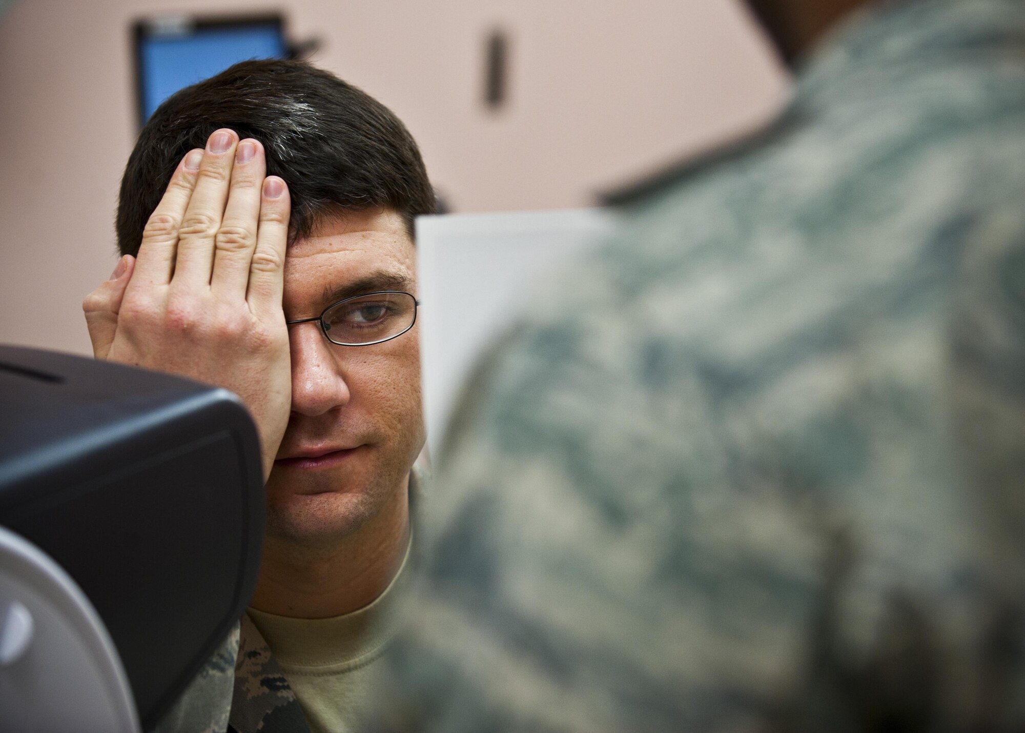 Staff Sgt. Shane Lahaie receives an eye exam during an occupational health exam Jan. 10, 2014, at Nellis Air Force Base, Nev. An eye exam assesses vision and ability to focus on and discern objects. Lahaie is a 820th REDHORSE power production journeyman. (U.S. Air Force photo/Senior Airman Brett Clashman)