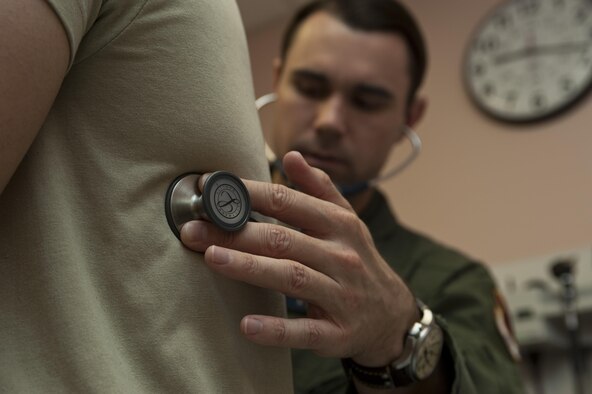 Capt. (Dr.) Thomas Shute listens to a patient’s breathing during a follow-up occupational health exam Jan. 10, 2014, at Nellis Air Force Base, Nev. Flight surgeons are responsible for maintaining and treating all pilots, aircrew and flightline workers in support of flying operations. Shute is a 42nd Attack Squadron flight surgeon. (U.S. Air Force photo/Airman 1st Class Timothy Young)