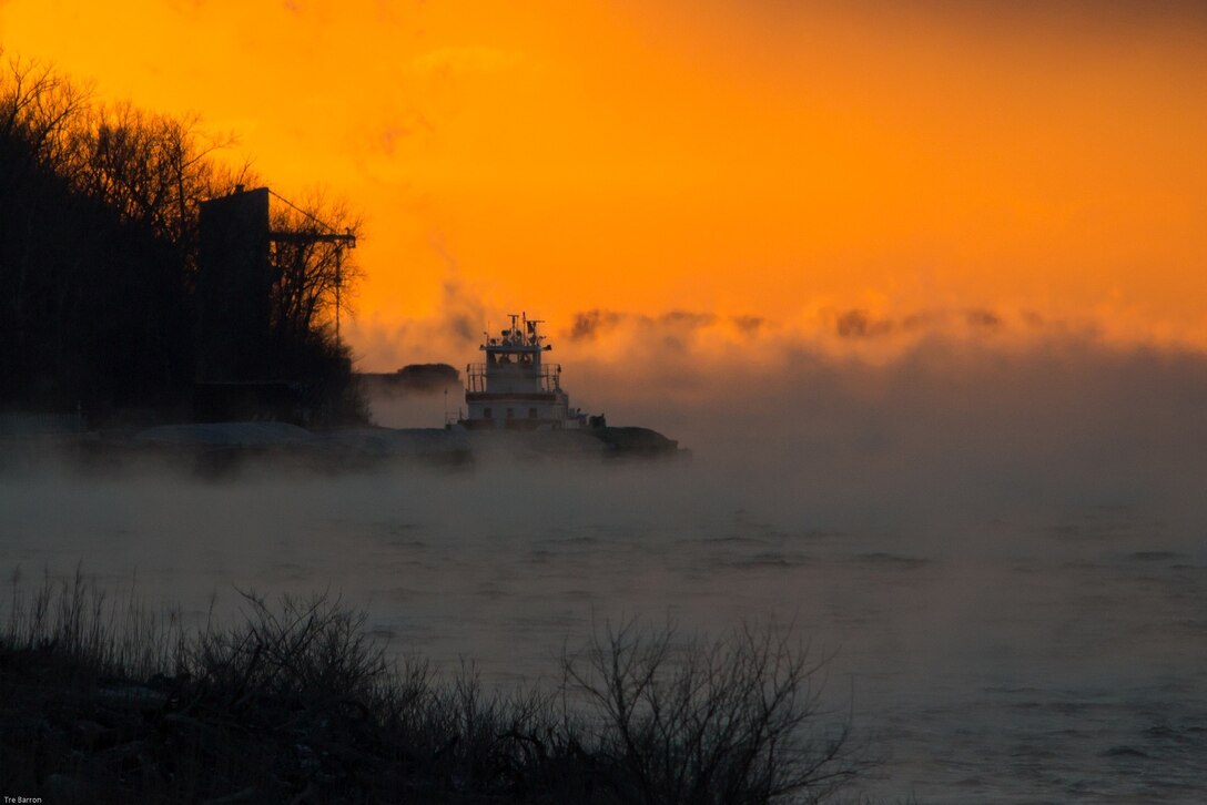 On a frigid morning, fog obscures a tow bound for Newburgh Locks and Dam on the Ohio River.