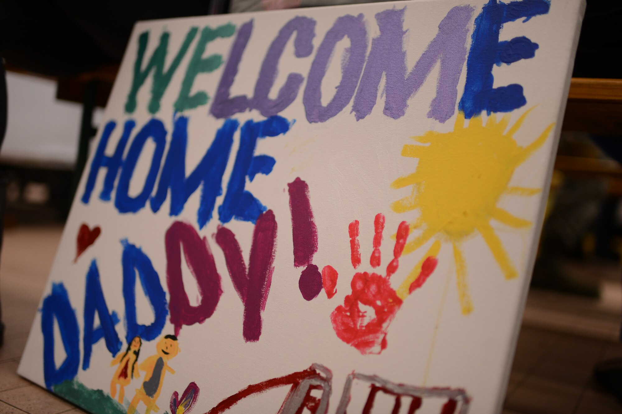 SPANGDAHLEM AIR BASE, Germany – A sign is displayed to welcome home a father who is returning after a six-month deployment with the 606th Air Control Squadron Jan. 15, 2014. The 606th ACS previously deployed to Southwest Asia in 2008 and 2010 to provide Air Defense for the Arabian Gulf.  (U.S. Air Force photo by Senior Airman Gustavo Castillo/Released)