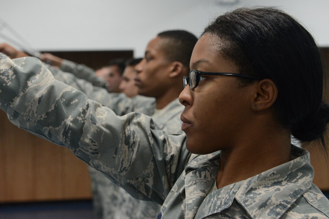 Senior Airman Angel Mingo, Andersen Blue Knights Honor Guard team member, practices the movements used to form a sword cordon Jan. 8, 2014, on Andersen Air Force Base, Guam in preparation for the upcoming annual award ceremony. The honor guard’s mission is to maintain and employ a ceremonial capability to represent the Air Force at public and official ceremonies. (U.S. Air Force photo by Airman 1st Class Emily A. Bradley/Released)