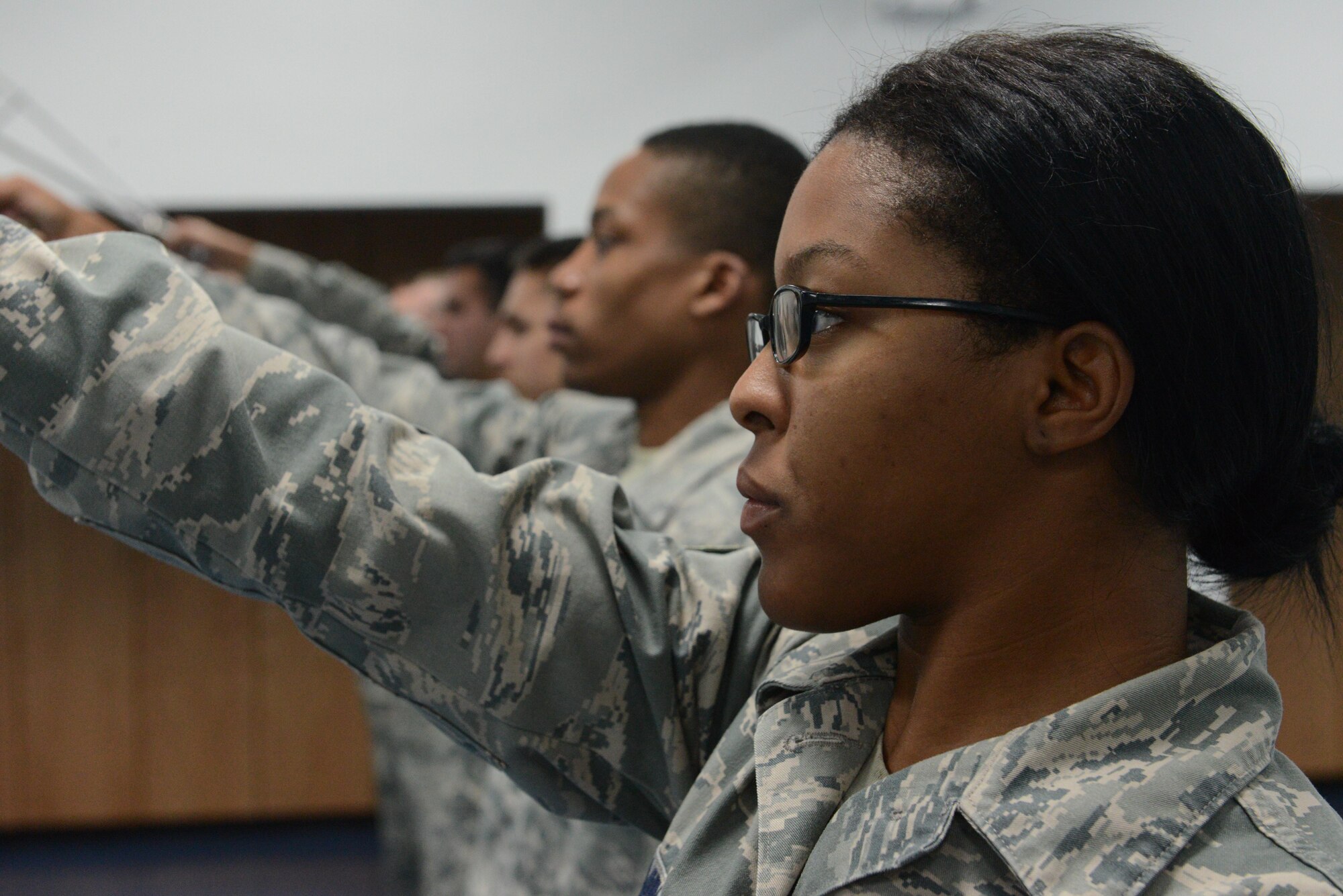 Senior Airman Angel Mingo, Andersen Blue Knights Honor Guard team member, practices the movements used to form a sword cordon Jan. 8, 2014, on Andersen Air Force Base, Guam in preparation for the upcoming annual award ceremony. The honor guard’s mission is to maintain and employ a ceremonial capability to represent the Air Force at public and official ceremonies. (U.S. Air Force photo by Airman 1st Class Emily A. Bradley/Released)