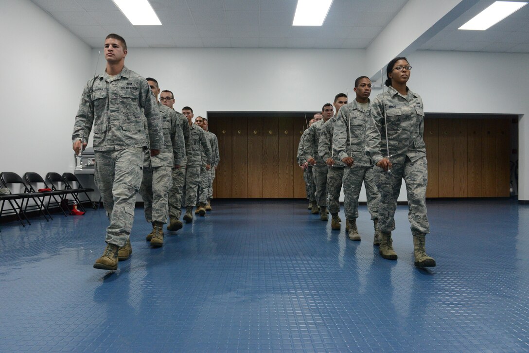 The Andersen Blue Knights Honor Guard team members practice marching with their swords Jan. 8, 2014, on Andersen Air Force Base, Guam, in preparation for the upcoming annual awards ceremony. The honor guard’s mission is to maintain and employ a ceremonial capability to represent the Air Force at public and official ceremonies. (U.S. Air Force photo by Airman 1st Class Emily A. Bradley/Released)