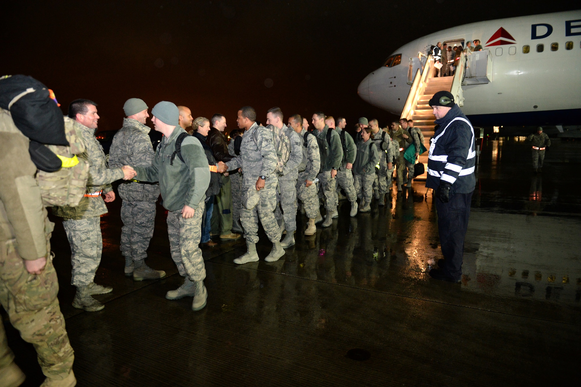 SPANGDAHLEM AIR BASE, Germany – U.S. Air Force Airmen step off a plane after returning from a six-month deployment to Southwest Asia Jan. 15, 2014. The 606th Air Control Squadron is one of the 52nd Operations Group’s three squadrons which comprise the flying component of the 52nd Fighter Wing. (U.S. Air Force photo by Senior Airman Alexis Siekert/Released)