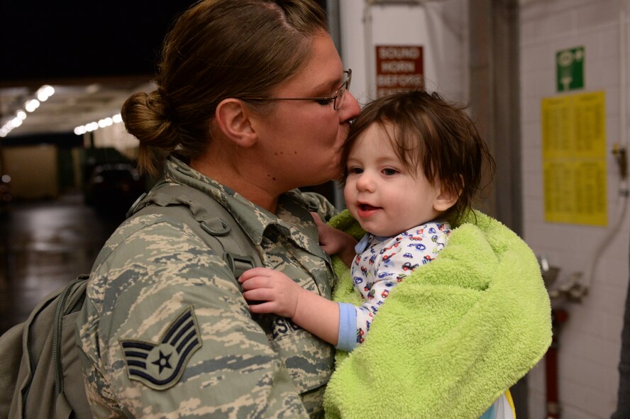 SPANGDAHLEM AIR BASE, Germany – U.S. Air Force Staff Sgt. Ashley Estep, 606th Air Control Squadron, kisses her child, Isaiah, Jan. 15, 2014. The 606th ACS departed for Southwest Asia July 10, 2013, to provide air defense of the Arabian Gulf in support of Operation Enduring Freedom. (U.S. Air Force photo by Staff Sgt. Daryl Knee/Released)