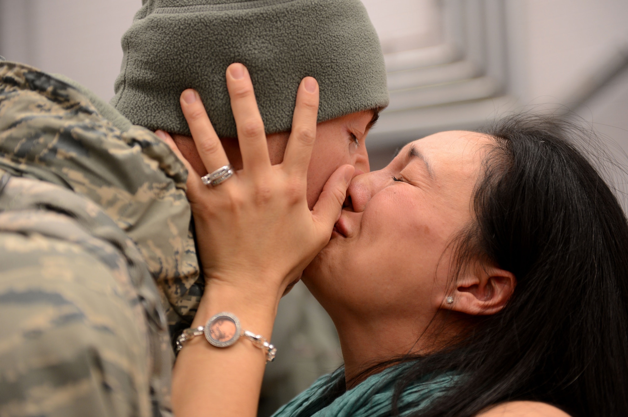 SPANGDAHLEM AIR BASE, Germany – U.S. Air Force Capt. Joe Faraone, 606th Air Control Squadron, is reunited with his wife, Suk Faraone, Jan. 15, 2014, after a six-month deployment. The 606th ACS supported the entire Afghanistan area of responsibility by providing the 251,000-square mile area with persistent long range radar, data links and radio communication capability at a greater than 99 percent mission effective rate during their deployment. (U.S. Air Force photo by Airman 1st Class Kyle Gese/Released)