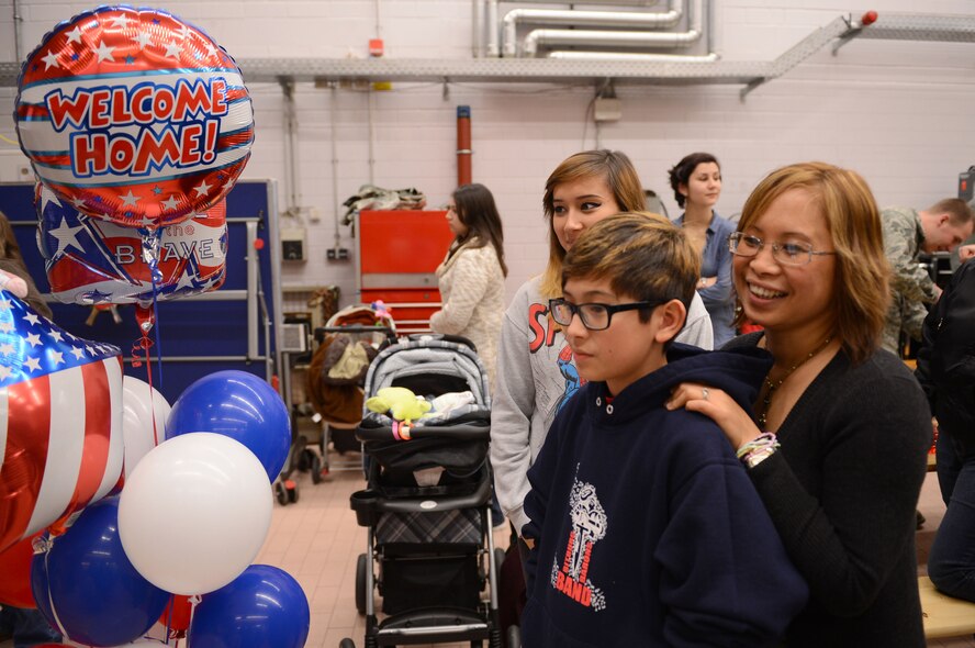 SPANGDAHLEM AIR BASE, Germany – Naomi Boucher and her children, Mariah and John, wait to welcome home husband and father Master Sgt. Mark Boucher, 606th Air Control Squadron, Jan. 15, 2014, following his deployment to Southwest Asia. The 606th ACS is a self-sustaining squadron consisting of maintenance, supply and approximately 19 other specialties. (U.S. Air Force photo by Airman 1st Class Kyle Gese/Released)
