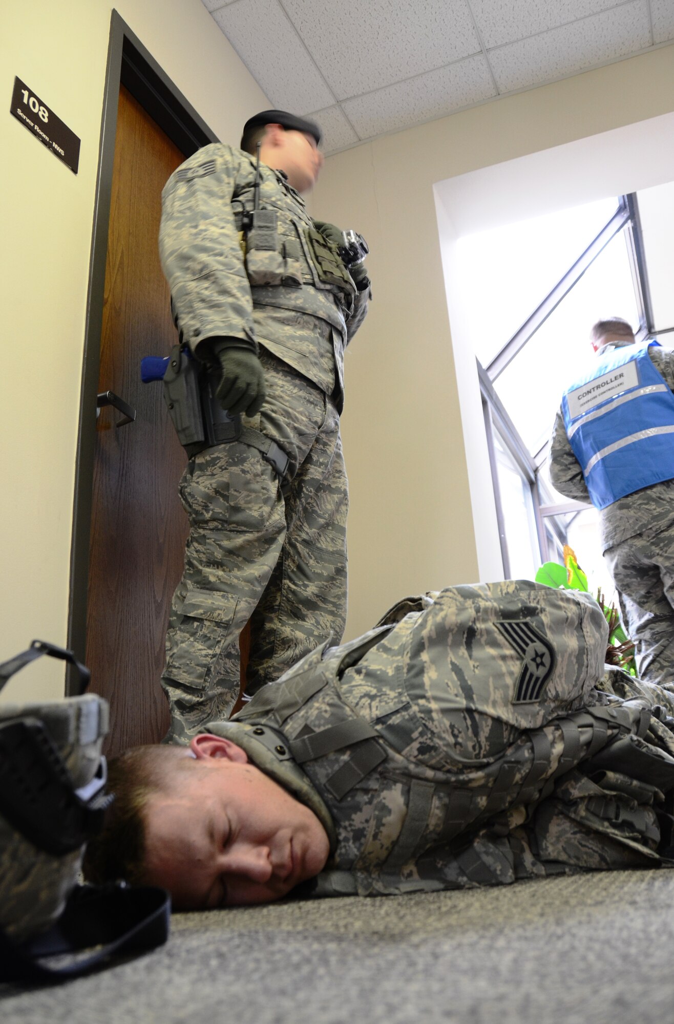 A Maryland Air National Guard Security Forces Airman stands over the body of a suspect in the civil engineering building at Martin State Airport on Wednesday, January 15, 2014 during an active shooter exercise. The exercise allowed first responders from the Warfield Air National Guard Base and the local police a chance to work together in a simulated situation. (Air National Guard photo by Tech. Sgt. David Speicher/RELEASED)







 


 


