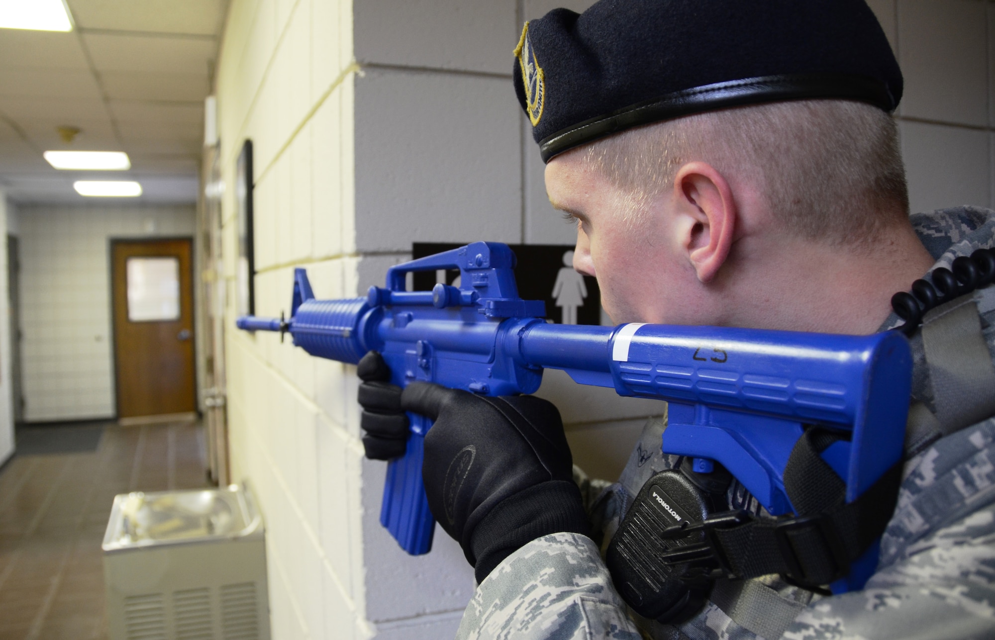 A Maryland Air National Guard Security Forces Airman trains his weapon down a hallway in the civil engineering building at Martin State Airport on Wednesday, January 15, 2014 during an active shooter exercise. The exercise allowed first responders from the Warfield Air National Guard Base and the local police a chance to work together in a simulated situation. (Air National Guard photo by Tech. Sgt. David Speicher/RELEASED)



 


 


