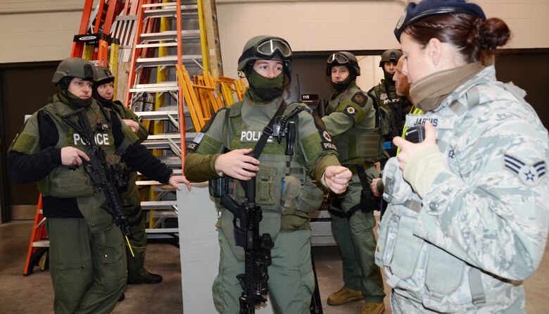 Baltimore County Police SWAT team members and Maryland Air National Guard Security Forces debrief after sweeping the civil engineering building at Martin State Airport on Wednesday, January 15, 2014 after looking for an active shooter during an exercise. The active shooter exercise allowed first responders from the Warfield Air National Guard Base and the local police a chance to work together in a simulated situation. (Air National Guard photo by Tech. Sgt. David Speicher/RELEASED)

 


 


