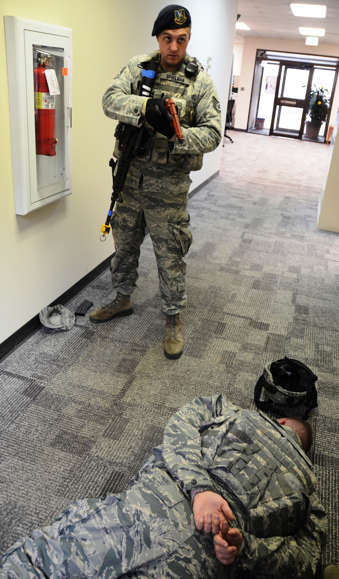 After a suspect is handcuffed a Maryland Air National Guard Security Forces Airman stands by in the civil engineering building at Martin State Airport on Wednesday, January 15, 2014 during an active shooter exercise. The exercise allowed first responders from the Warfield Air National Guard Base and the local police a chance to work together in a simulated situation. (Air National Guard photo by Tech. Sgt. David Speicher/RELEASED)

 


