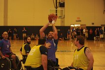 Senior Airman (retired) Ryan Gallo, Air Force wounded warrior, shoots a basket against the Navy wounded warriors during the inaugural Wounded Warrior Pacific Invitational at Joint Base Pearl Harbor-Hickam, Hawaii, Jan. 9, 2014. The game was part of the adaptive athletic reconditioning program to help wounded warriors build strength and endurance, while they draw inspiration from their teammates. (U.S. Air Force photo/Master Sgt. Matthew McGovern)