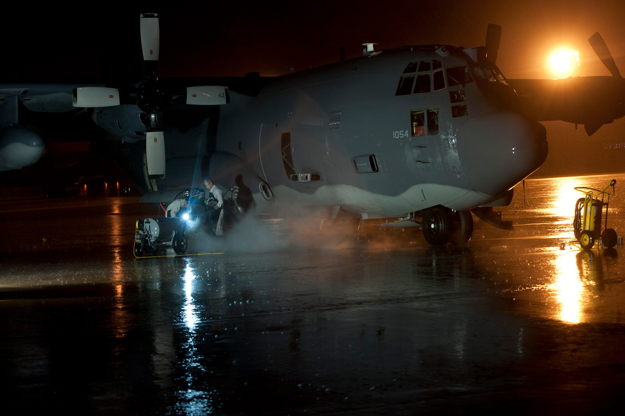 Staff Sgt. Luke Brackin and Airman 1st Class Mark Sherwood, 1st Special Operations Aircraft Maintenance Squadron  crew chiefs, service an aircraft with LOX on the flightline at Hurlburt Field, Fla., Jan. 13, 2014. Aircraft are filled with liquid oxygen to provide air for personnel on board. (U.S. Air Force photo/Senior Airman Krystal M. Garrett) 