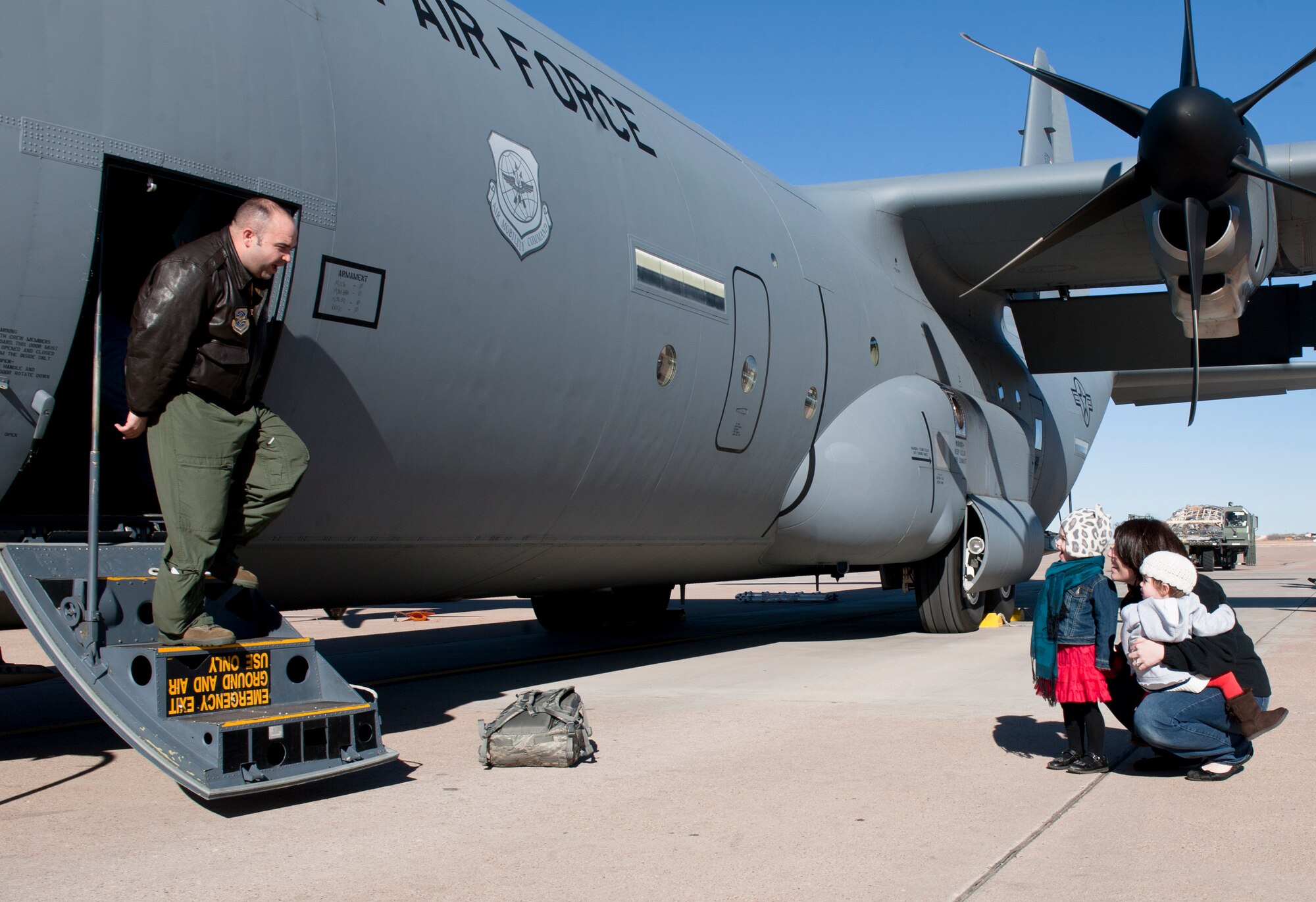 U.S. Air Force Maj. Jeff Noble, 317th Operations Support Squadron, is greeted by his family upon returning from a deployment Jan. 13, 2014, at Dyess Air Force Base, Texas. Several squadrons from the 317th Airlift Group were integrated with the 37th Airlift Squadron while deployed to Ramstein Air Base, Germany. (U.S. Air Force photo by Airman 1st Class Alexander Guerrero/Released)