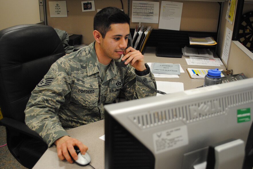 Staff Sgt. Abraham Cordero, an aviation resource management specialist with the 348th Reconnaissance Squadron, takes a call at the ASRM office on Grand Forks Air Force Base, N.D., Jan. 15, 2014. The six-year Air Force veteran from Orange County, Calif., was named the Grand Forks Air Force Base, N.D.’s, Warrior of the Week for the third week of January 2014. (U.S. Air Force photo/Staff Sgt. Luis Loza Gutierrez) 