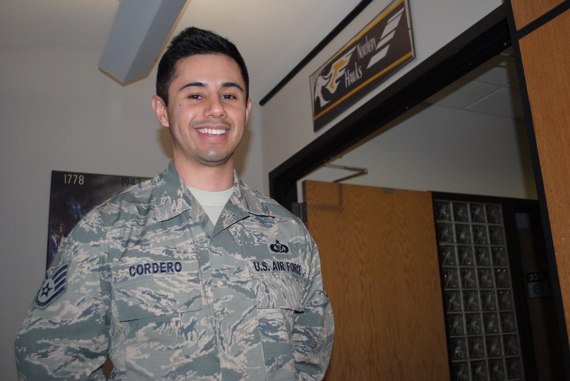 Staff Sgt. Abraham Cordero smiles after being congratulated by his coworkers for being named Warrior of the Week for the third week of January 2014. Cordero is an aviation resource management specialist with the 348th Reconnaissance Squadron on Grand Forks Air Force Base, N.D. (U.S. Air Force photo/Staff Sgt. Luis Loza Gutierrez) 
