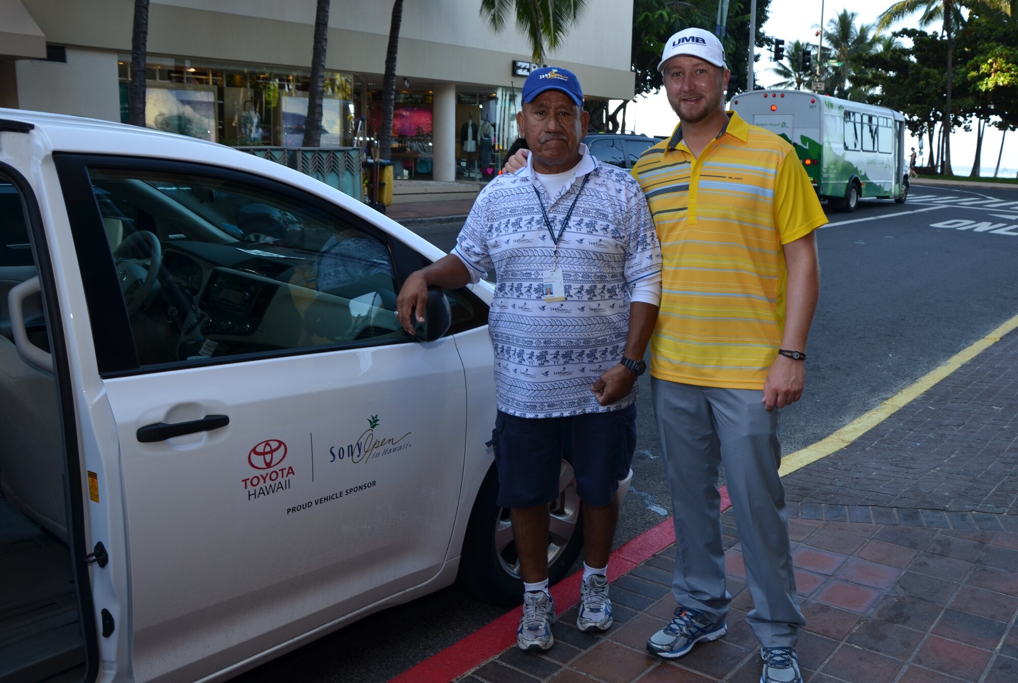 Master Sgt. Larry Castillo, left, a cargo manager with the 48th Aerial Port Squadron, poses for a photo with PGA Tour golfer Brice Garnett, right, in front of the Waikiki hotel where Garnett was staying during the Sony Open golf tournament, Honlulu, Hawaii, Jan. 12, 2014. Castillo drove Garnett to the Waialae Country Club for his 10:45 tee time on the final day of the tournament. Garnett, a standout from the state of Missouri, was playing in the tournament for the first time. (U.S. Air Force photo by Tech. Sgt. Phyllis Keith)