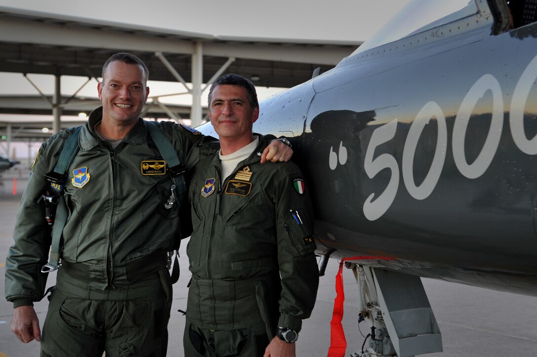 Col. Lance Bunch, 80th Flying Training Wing commander, and Italian Air Force Lt. Col. Michele Minonne, 469th Flying Training Squadron senior national representative, pose after completing Minonne’s 5,000th hour of flight training mission in a T-38 Talon at Sheppard Air Force Base, Texas, Jan. 6, 2013. Minonne has been assigned to Italian fighter aircraft such as the Fiat G91, AMX International and the Aermacchi MB339 A/CD.  However, a majority of his hours have been as an instructor pilot in the T-37 Tweet and T-38.  He has been teaching Airmen to fly as an instructor pilot since 1997. (U.S. Air Force photo/2nd Lt. Ava Margerison)