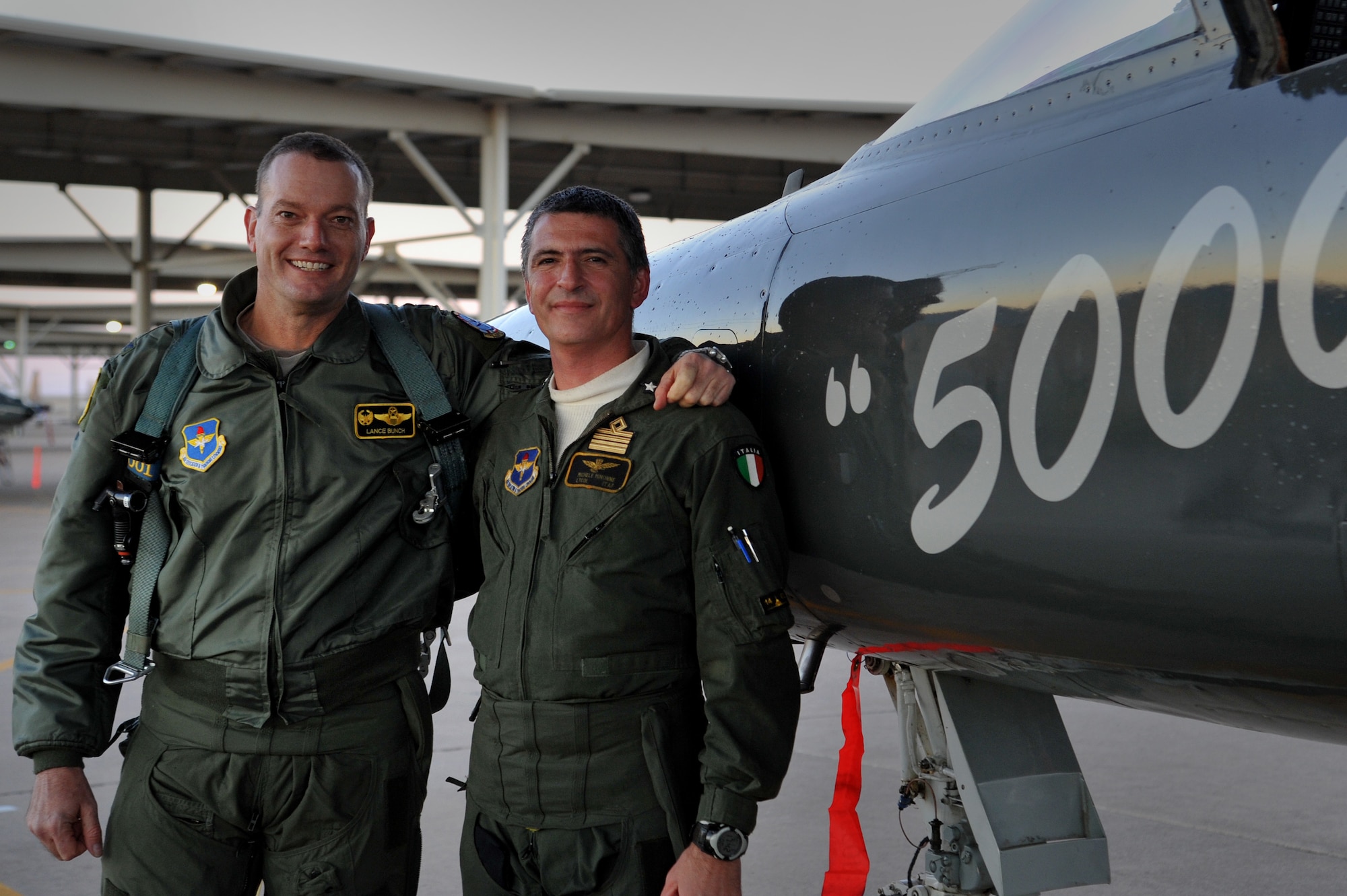 Col. Lance Bunch, 80th Flying Training Wing commander, and Italian Air Force Lt. Col. Michele Minonne, 469th Flying Training Squadron senior national representative, pose after completing Minonne’s 5,000th hour of flight training mission in a T-38 Talon at Sheppard Air Force Base, Texas, Jan. 6, 2013. Minonne has been assigned to Italian fighter aircraft such as the Fiat G91, AMX International and the Aermacchi MB339 A/CD.  However, a majority of his hours have been as an instructor pilot in the T-37 Tweet and T-38.  He has been teaching Airmen to fly as an instructor pilot since 1997. (U.S. Air Force photo/2nd Lt. Ava Margerison)
