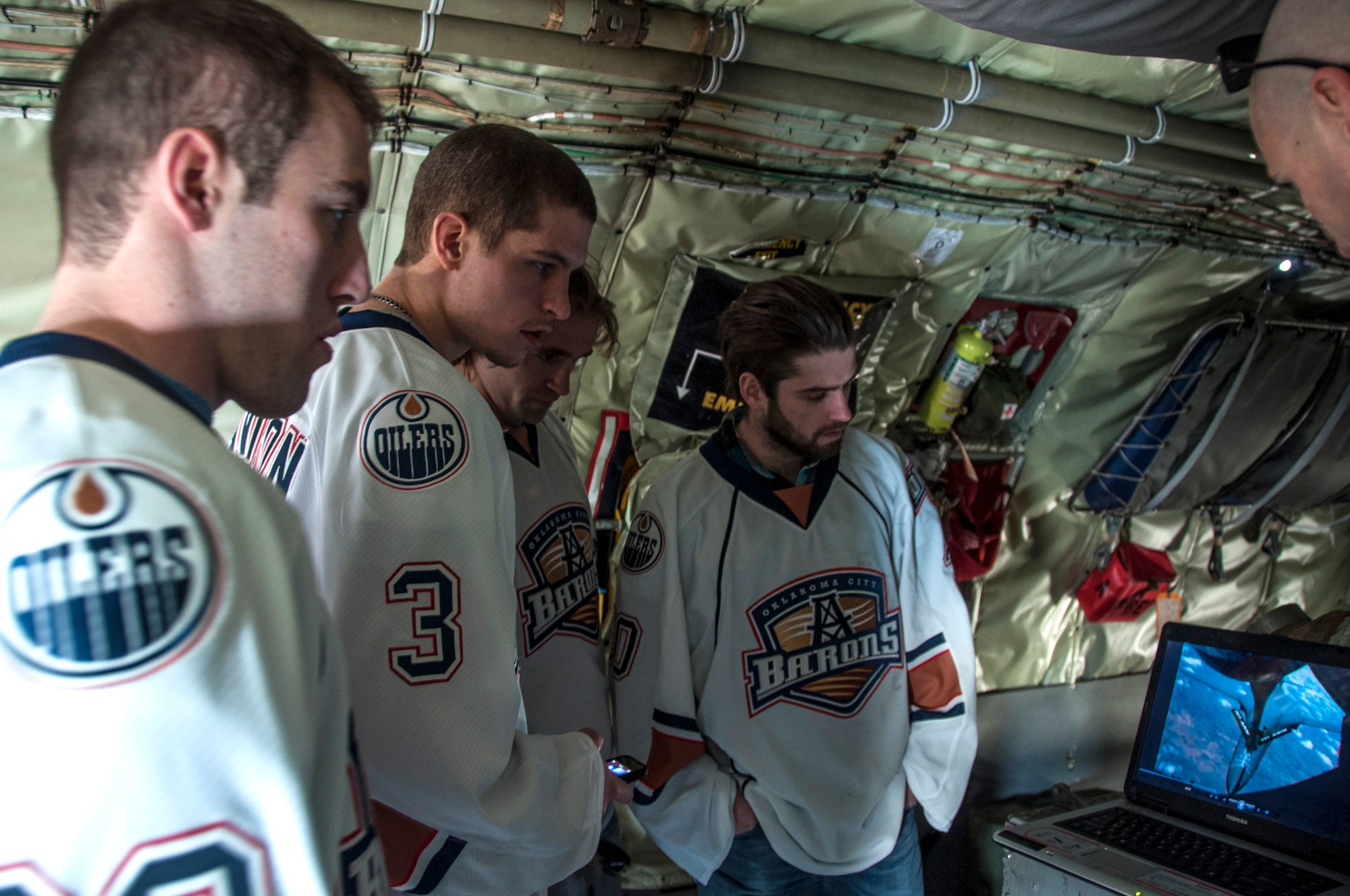 Members from the Oklahoma City Barons hockey team watch a video of an aerial refueling while touring a KC-135R Stratotanker here January 14, 2014.  The players volunteered for a floor hockey game as part of a winning raffle by 507th Civil Engineering Squadron’s Senior Master Sgt. Daniel Bostwick.  Five members from the 507th and 137th Oklahoma Air National Guard Air Refueling Wings participated in the game as dozens more took time to come watch.  The Oklahoma City Barons are part of the National Hockey League’s Edmonton Oilers.  (U.S. Air Force photo/Senior Airman Mark Hybers)