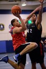 Gerardo Andujar-Siaca, 3rd Space Operations Squadron, pulls up for a layup during the second half of a Schriever intramural basketball league game here Jan. 15. Napoleon Tavale from the combined 1st Space Operations Squadron and 50th Space Communications Squadron, defends on the play. Andujar-Siaca and 3 SOPS went on to claim a 52-42 victory and remain atop the league standings with an 8-0 record. (U.S.Air Force photo by Christopher DeWitt)
