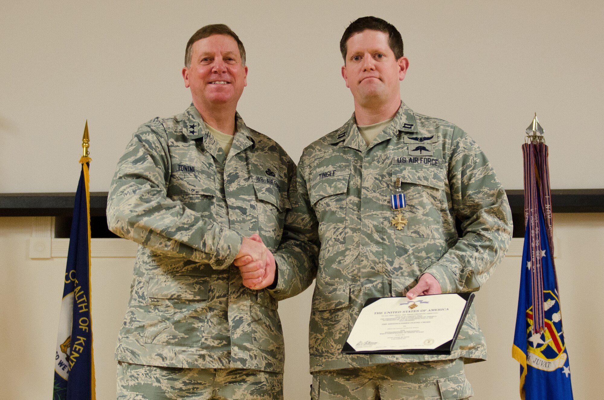 Kentucky’s adjutant general, Maj. Gen. Edward W. Tonini, presents Capt. Nathan Tingle, a combat rescue officer in the 123rd Special Tactics Squadron, with the Distinguished Flying Cross during an award ceremony held Jan. 12, 2014 at the Kentucky Air National Guard Base in Louisville, Ky. Tingle earned the award for extraordinary achievement while conducting rescue operations in Afghanistan in 2011. (U.S. Air National Guard photo by Airman 1st Class Joshua Horton)