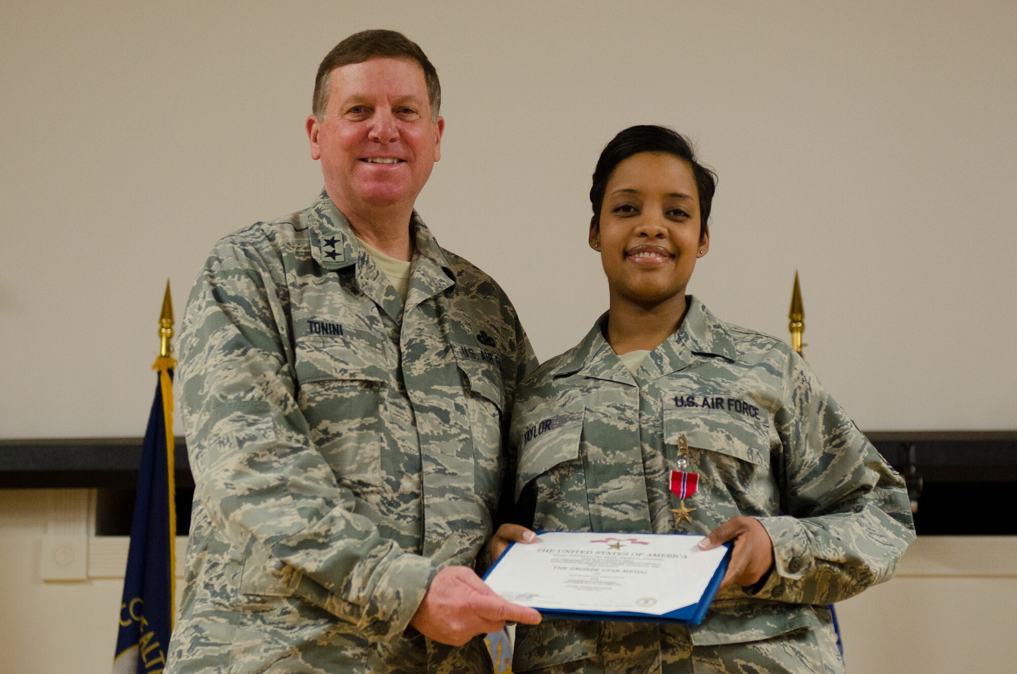 Kentucky’s adjutant general, Maj. Gen. Edward W. Tonini, presents Master Sgt. Zakiya Taylor with the Bronze Star Medal during an award ceremony held Jan. 12, 2014 at the Kentucky Air National Guard Base in Louisville, Ky. Taylor earned the award for exceptionally meritorious achievement while serving in Afghanistan as part of Kentucky Agribusiness Development Team V, a multi-disciplinary task force charged with helping the nation develop a sustainable farming economy. (U.S. Air National Guard photo by Airman 1st Class Joshua Horton)