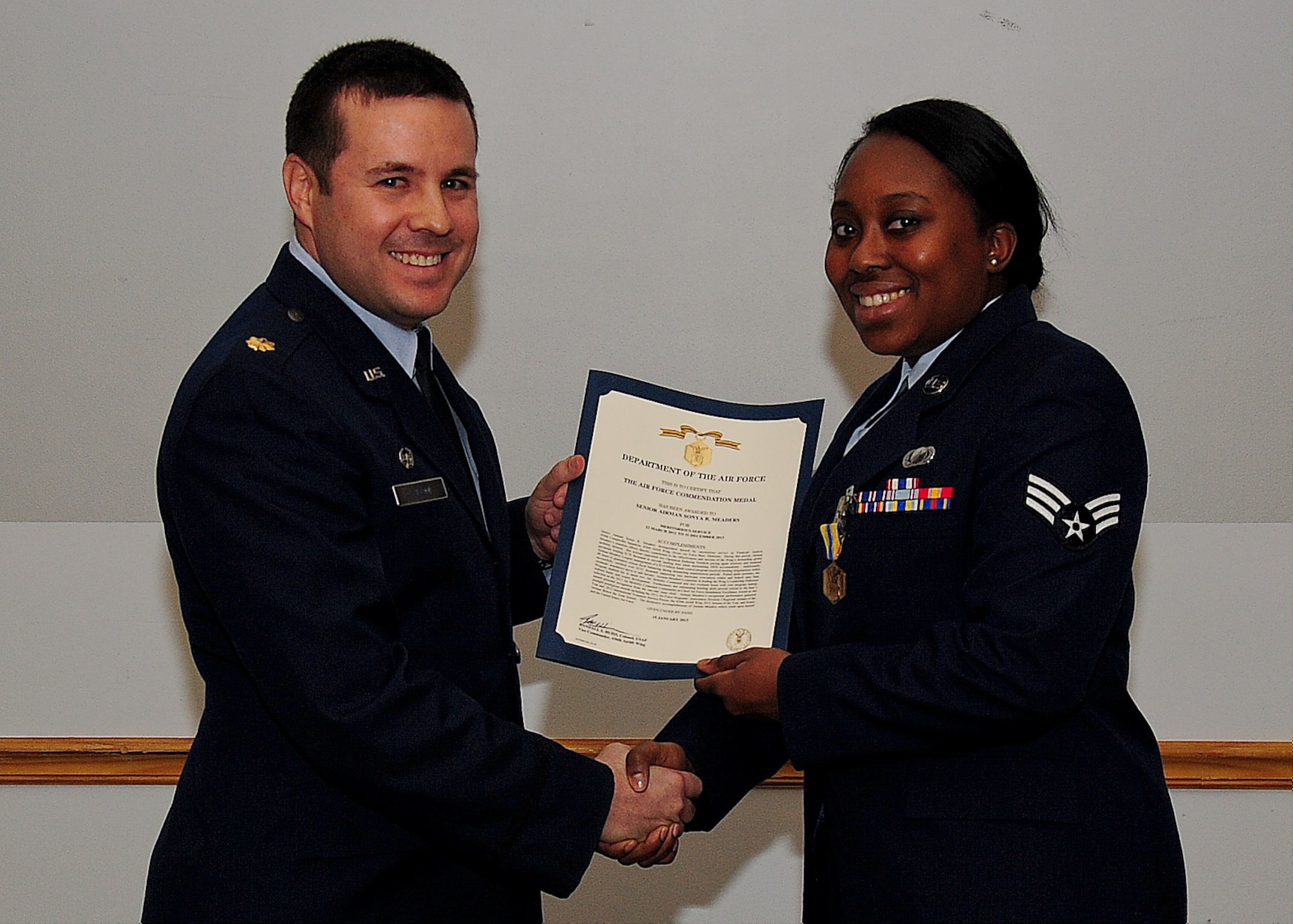 Maj. William Vivoni, 436th Comptroller Squadron commander, presents Senior Airman Sonya Yelbert, 436th CPTS financial analyst, with the Air Force Commendation Medal Jan. 10, 2014, at Dover Air Force Base, Del. This was just one of the many awards Yelbert has won throughout her enlisted career. (U.S. Air Force photo/Airman 1st Class Ashlin Federick)