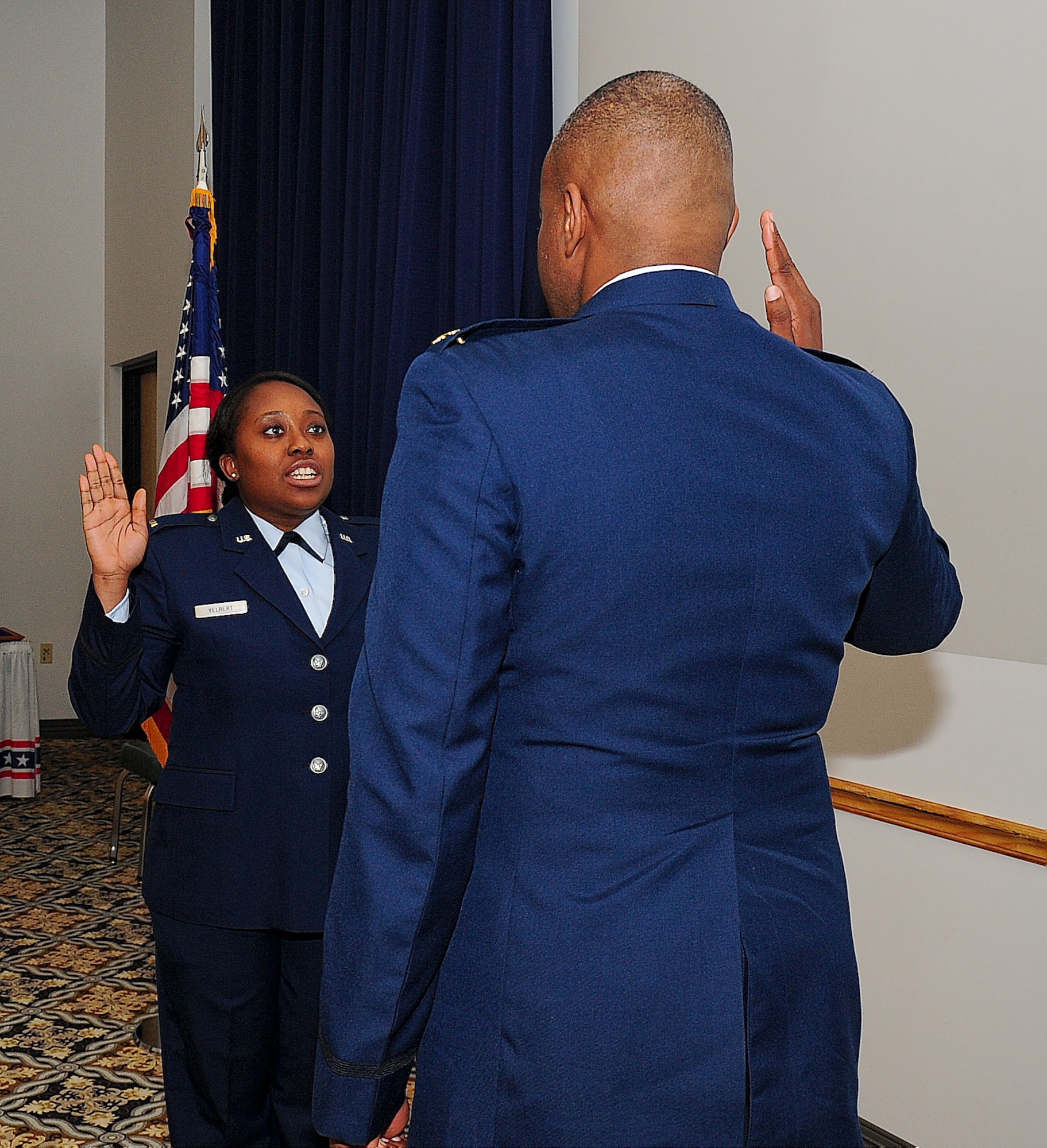 Maj. Edward Small, U.S. Air Forces Europe strategic planner at Ramstein Air Base, Germany, administers the oath of office to his niece Senior Airman Sonya Yelbert, 436th Comptroller Squadron financial analyst, Jan. 10, 2014, at Dover Air Force Base, Del. Yelbert commissioned into the Medical Service Corps as a second lieutenant. (U.S. Air Force photo/Airman 1st Class Ashlin Federick)