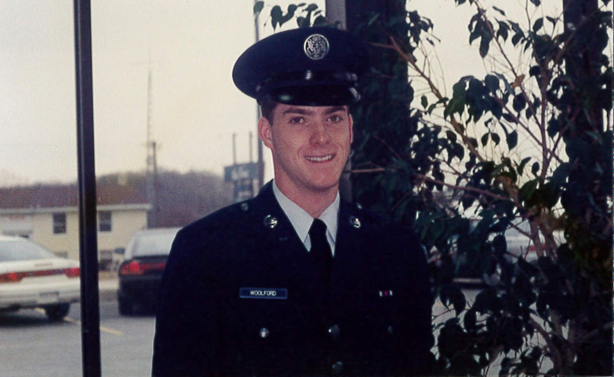 Then, Airman Jeffrey Woolford, a crew chief, poses for a photo in his dress uniform shortly after graduating U.S. Air Force Basic Military Training. Maj. (Dr.) Woolford enlisted in the Air Force as an aircraft maintenance crew chief in 1989, and commissioned as an A-10 Thunderbolt II pilot in 1998. (U.S. Air Force courtesy photo)