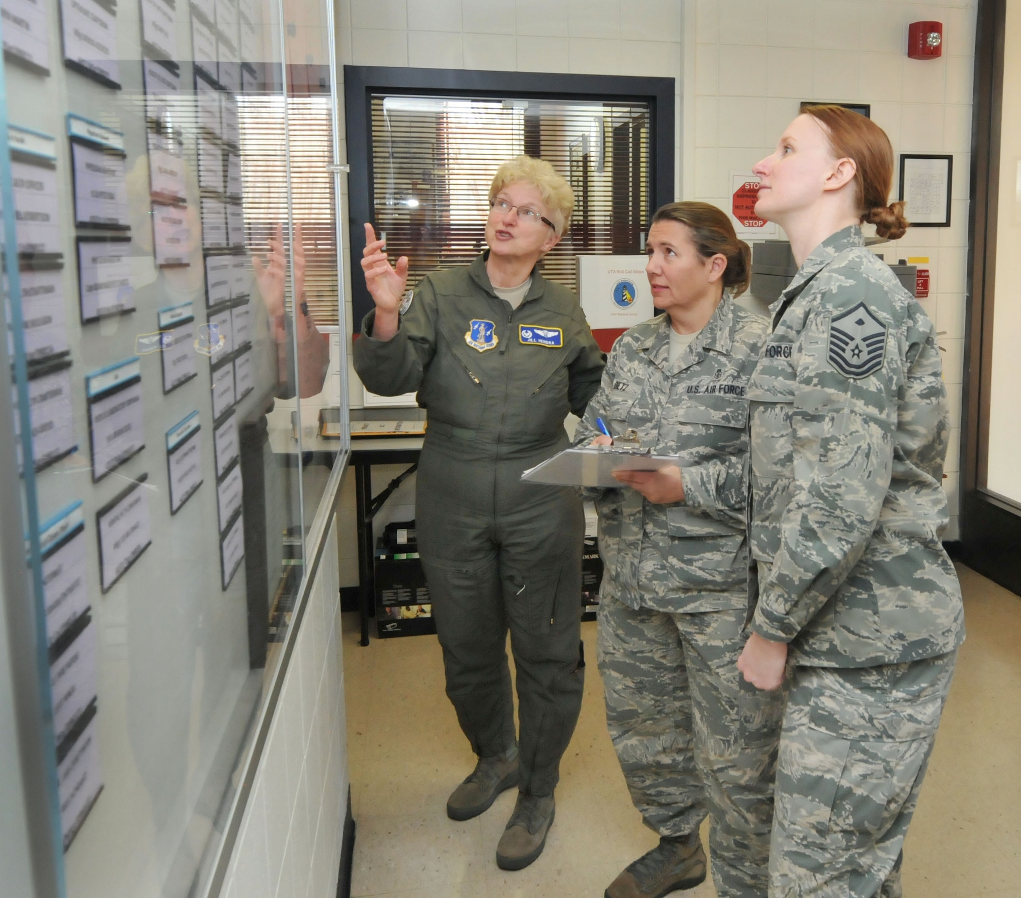 U.S. Air Force Master Sgt. Maria Gupton, first female 1st Shirt for the 145th Medical Group, Chief Master Sgt. Susan Dietz, first female Chief Enlisted Manager, 145th MDG and Col. Jill Hendra, first female commander 145th MDG, coordinate manning of personnel and plan training schedule prior to upcoming “Superdrill” Unit Training Assembly at the North Carolina Air National Guard base, Charlotte-Douglas Intl. airport, Jan. 8, 2014.  January UTA will be Hendra’s final drill as commander of the 145th MDG. (Air National Guard photo by Master Sgt. Patricia F. Moran/Released)