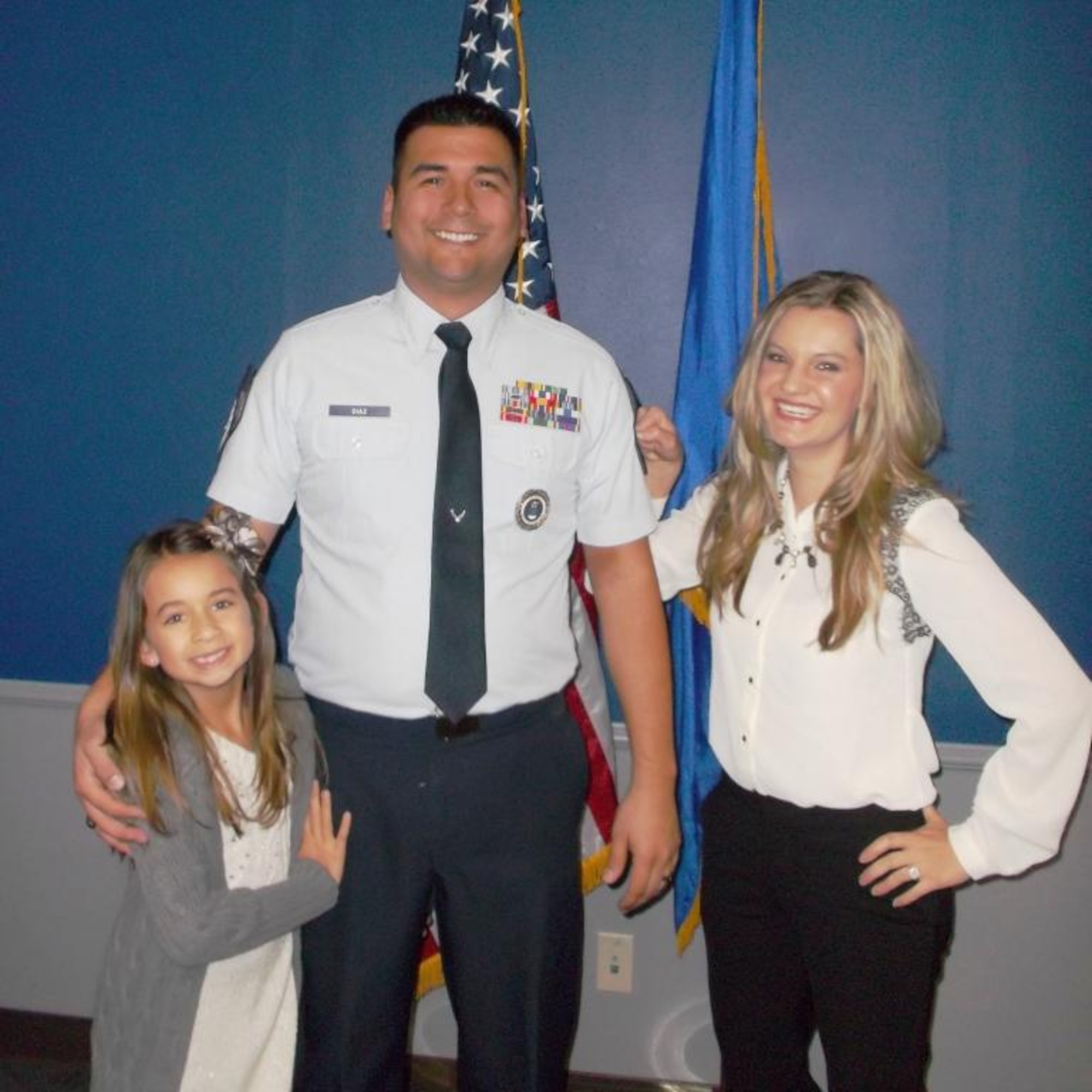 Newly promoted Master Sgt. Brett Diaz is all smiles with his wife, Ashlie, and daughter, Adisen, Dec. 20. (U.S. Air Force photo)