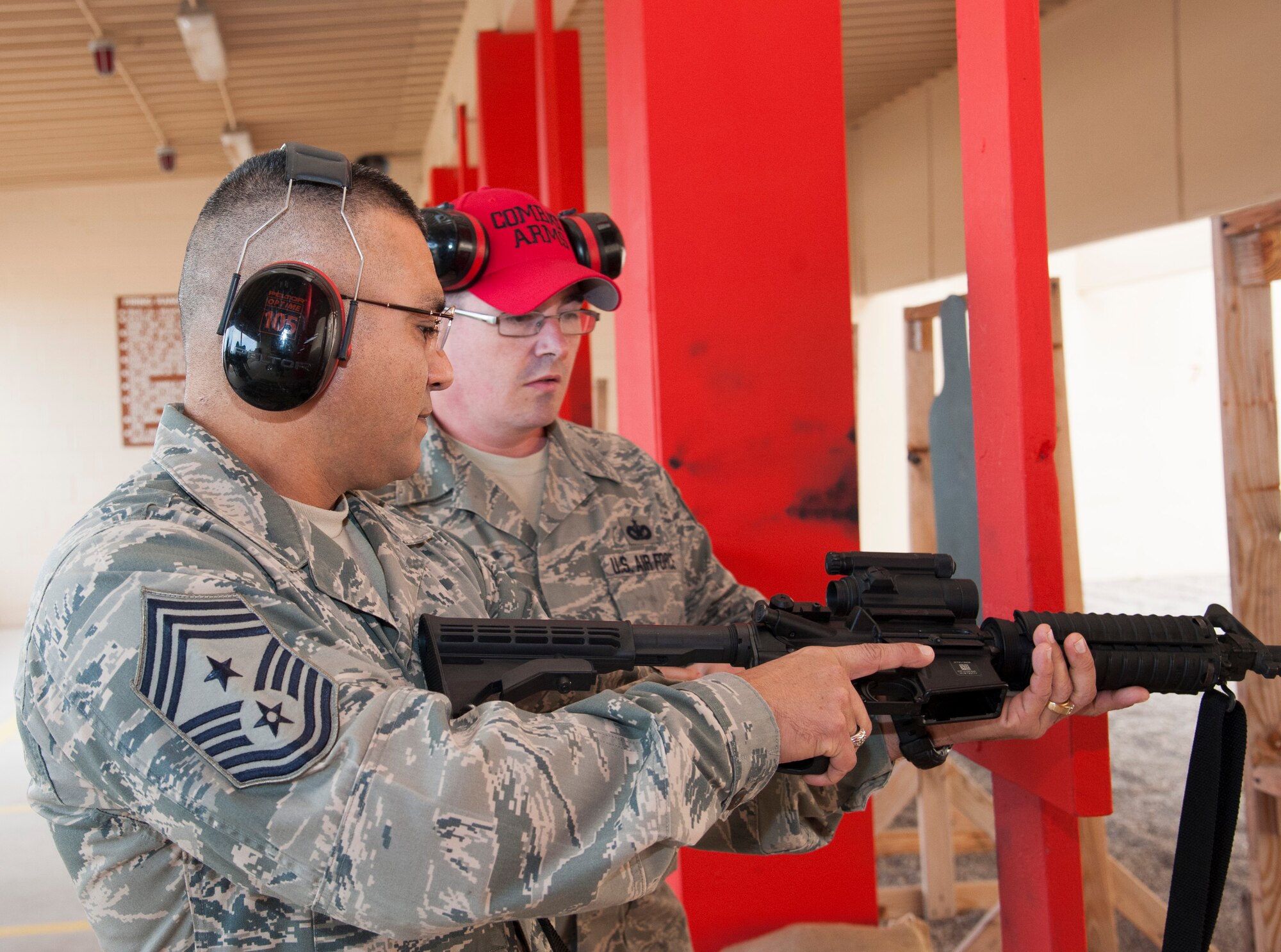 Chief Master Sgt. Gerardo Tapia, Air Education and Training Command command chief, checks a rifle before loading it and prepares to shoot a rifle at the Combat Arms Training and Marksmanship range on Laughlin Air Force Base, Texas, Jan. 9, 2014. After firing the rifle he helped present the AETC Outstanding Security Forces Flight Level NCO of the Year Award to Staff Sgt. Tynesha Sweeney, 47th Security Forces Squadron report analysis technician. (U.S. Air Force photo/Airman 1st Class Jimmie D. Pike)