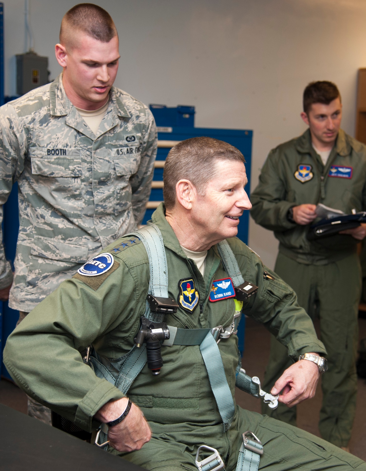 Gen. Robin Rand, Air Education and Training Command commander, unlatches a harness after getting fitted by Aircrew Flight Equipment at Laughlin Air Force Base, Texas, Jan. 8, 2014. He was fitted in a harness for a training sortie scheduled during his visit. (U.S. Air Force photo/Airman 1st Class Jimmie D. Pike)