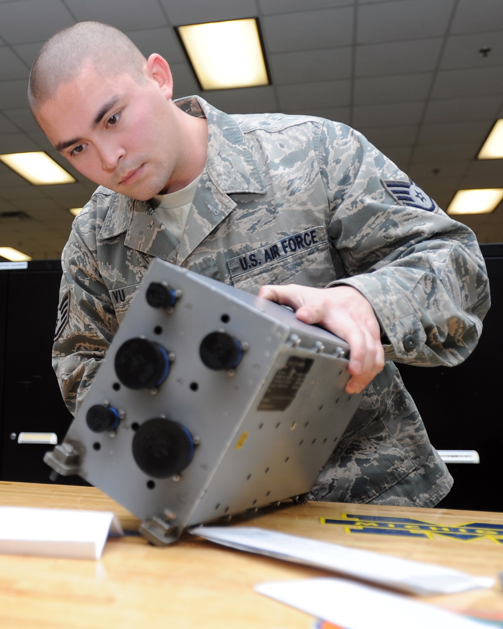Staff Sgt. Tyler Vu, 1st Special Operations Component Maintenance Squadron instrument and flight control systems craftsman, inspects a CV-22 Osprey part on Hurlburt Field, Fla., Jan. 14, 2014. Vu also reviews Enlisted Performance Reports, decorations and awards packages while ensuring day-to-day operations run smoothly at his shop. (U.S. Air Force photo/Senior Airman Kentavist P. Brackin)