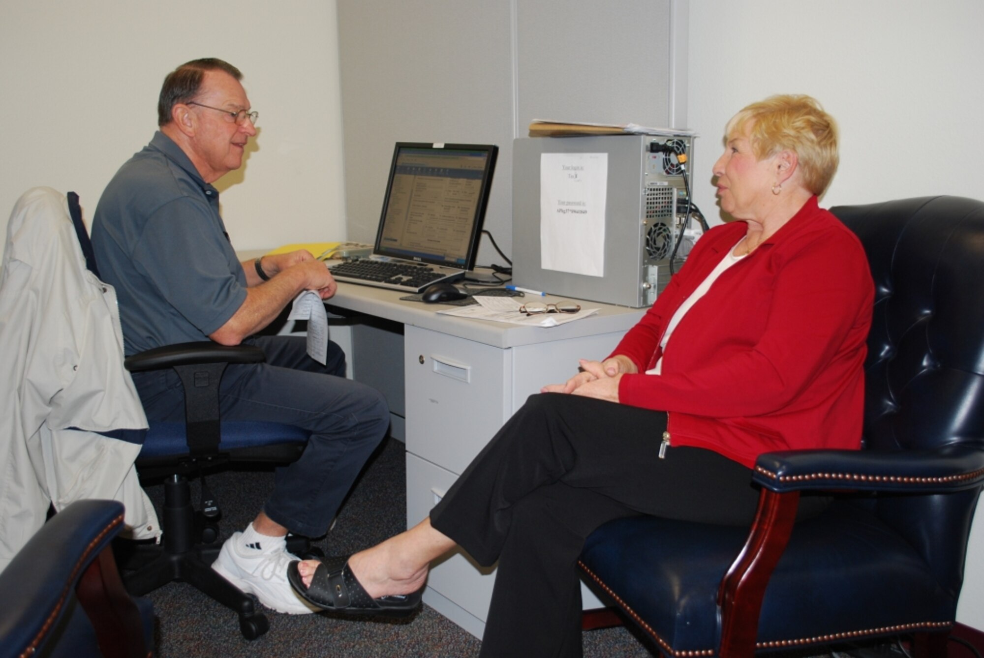 Don Winterich, Volunteer Income Tax Assistance Program manager, helps a client file her taxes at Patrick Air Force Base during the program in a previous year. “I encourage our clients to make an appointment as soon as they have obtained all their information so that we can manage our work load and minimize their wait time,” he said. (Courtesy photo)