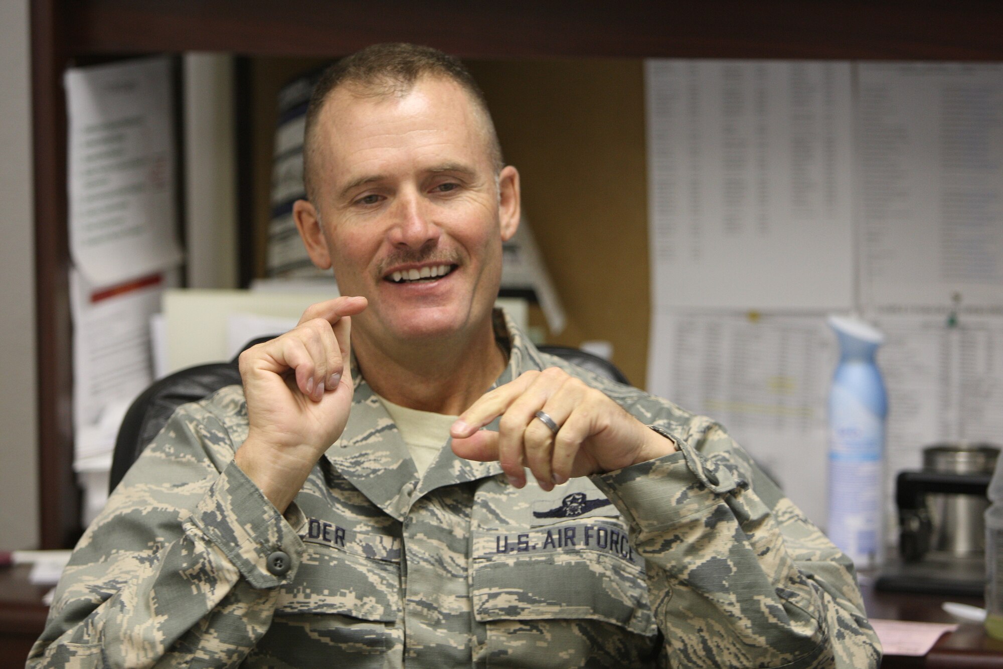 Wyo. Air National Guard Lt. Col. Dave Herder talks to a visitor while at his Camp Guernsey desk. Herder will leave the deputy commander position soon. (U.S. Army National Guard photo by Sgt. 1st Class Jimmy McGuire)