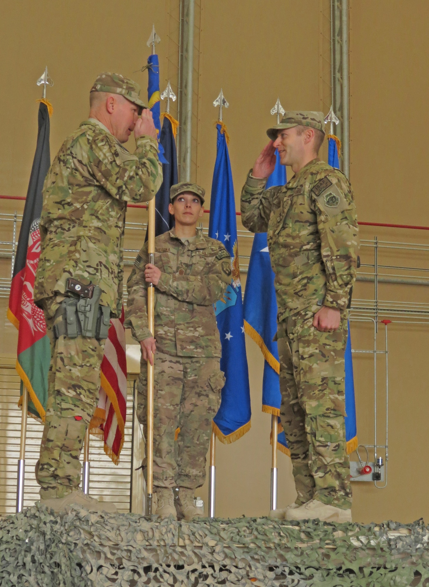 U.S. Air Force Brig. Gen. Patrick Malackowski, 455th Air Expeditionary Wing commander, salutes Col. Scott Campbell, 451st Air Expeditionary Group commander, in a transition ceremony at Kandahar Airfield, Afghanistan, Jan. 13, 2014. The 451st Air Expeditionary Wing was transitioned to an AEG due to a change in mission.(U.S. Air Force photo by Senior Airman Alexandria Bandin/Released)                    