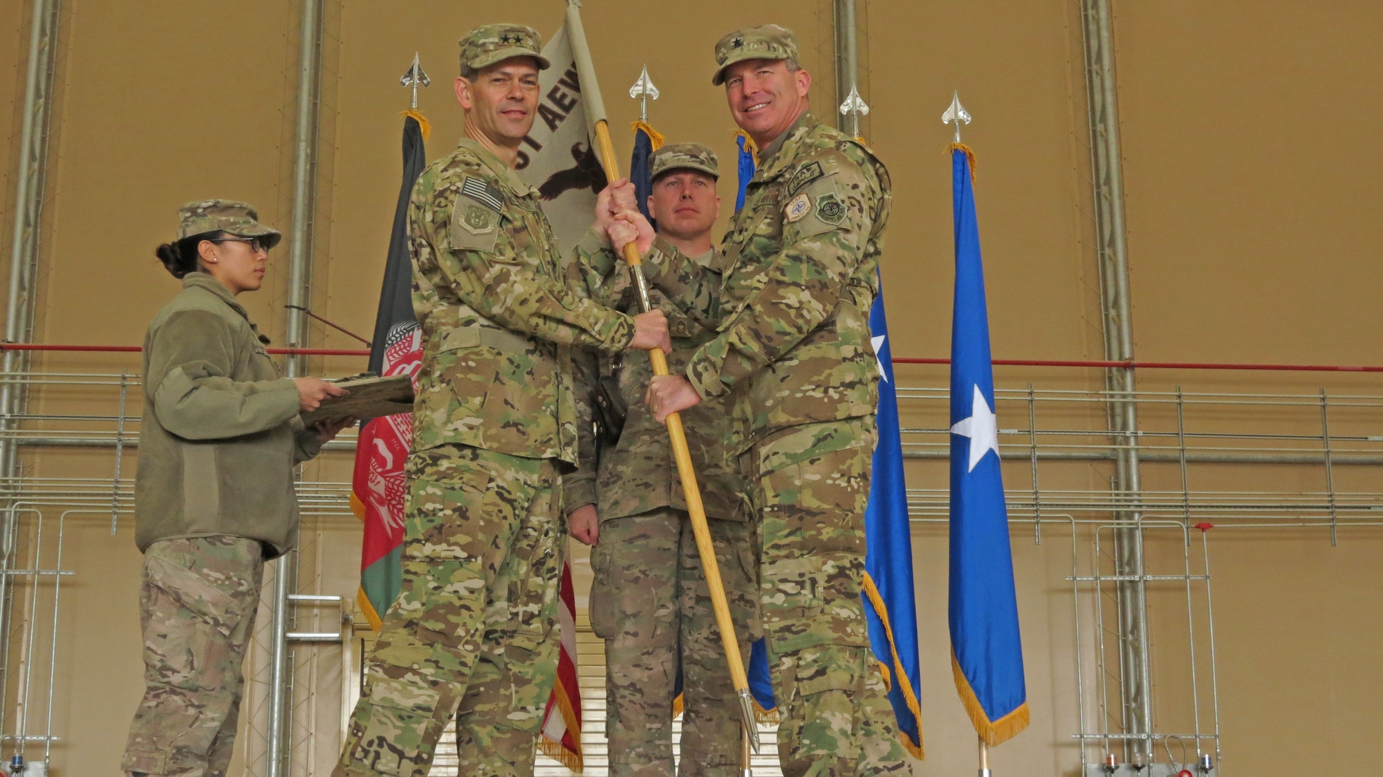 U.S. Air Force Maj. Gen. Kenneth Wilsbach, Commander, 9th Air and Space Expeditionary Task Force-Afghanistan; Deputy Commander-Air, U.S. Force-Afghanistan; and Deputy Chief of Staff-Air, International Security Assistance Force Joint Command, receives the 451st Air Expeditionary Wing guidon from Brig. Gen. Michael Frantini, 451st AEW commander and Commander, Kandahar Airfield, in a transition ceremony at Kandahar Airfield, Afghanistan, Jan. 13, 2014. The 451st Air Expeditionary Wing was transitioned to an Air Expeditionary Group due to a change in mission.(U.S. Air Force photo by Senior Airman Alexandria Bandin/Released)                                       