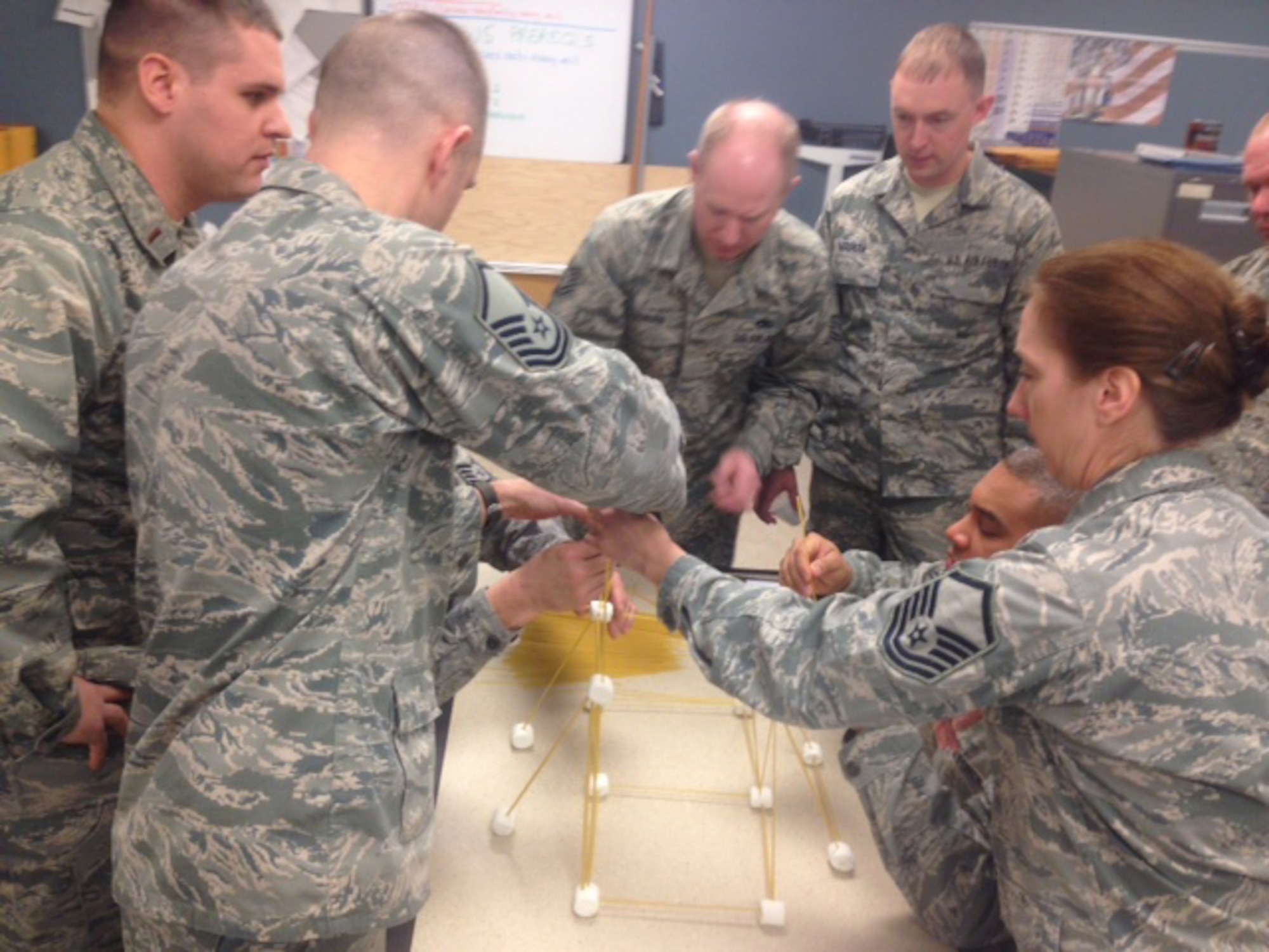 SCOTIA, N.Y. -- Air National Guardsmen construct a tower made of spaghetti and marshmallows during a team building exercise Jan. 11 at the 109th Airlift Wing's first Leadership Development Course. The three-day course, held by the 109th AW chief's council at the Naval Operations Support Center Jan. 10-12, 2014, covered topics including Profession of Arms, performance review writing, time management and career management. (Air National Guard photo by Chief Master Sgt. Mary Alice Rebis/Released)