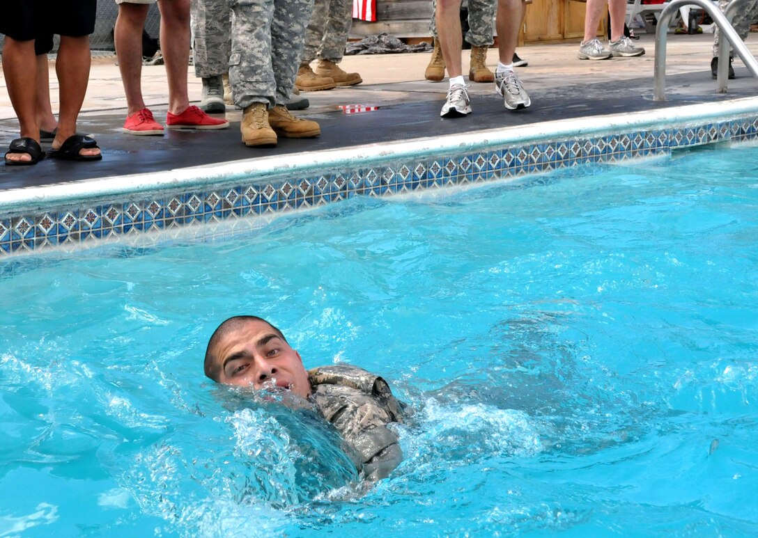 Members of Joint Task Force-Bravo participate in a 100 meter swim while in uniform during testing for the German Armed Forces Proficiency Badge at Soto Cano Air Base, Honduras, Jan. 14, 2014. Several members of Joint Task Force-Bravo are attempting to qualify for the German Armed Forces Proficiency Badge this week. In order to qualify for the badge, service members must pass both a fitness test and a military training test, administered by a German Sergeant Major. Today, JTF-Bravo members completed an 11x10 meter spring test, a chin-up (flexed arm hang) test, a 1,000 meter run and a 100 meter swim in uniform. The German Armed Forces Proficiency Badge (German: Abzeichen für Leistungen im Truppendienst) is a decoration of the Bundeswehr, the Armed Forces of the Federal Republic of Germany. The decoration can be awarded to all German Soldiers. Allied Soldiers may also be awarded the badge. Any rank may be awarded and wear the badge. In the United States Military the German Armed Forces Proficiency Badge is one of the few approved foreign awards, and it is one of the most sought after awards to achieve. (Photo by Ana Fonseca)