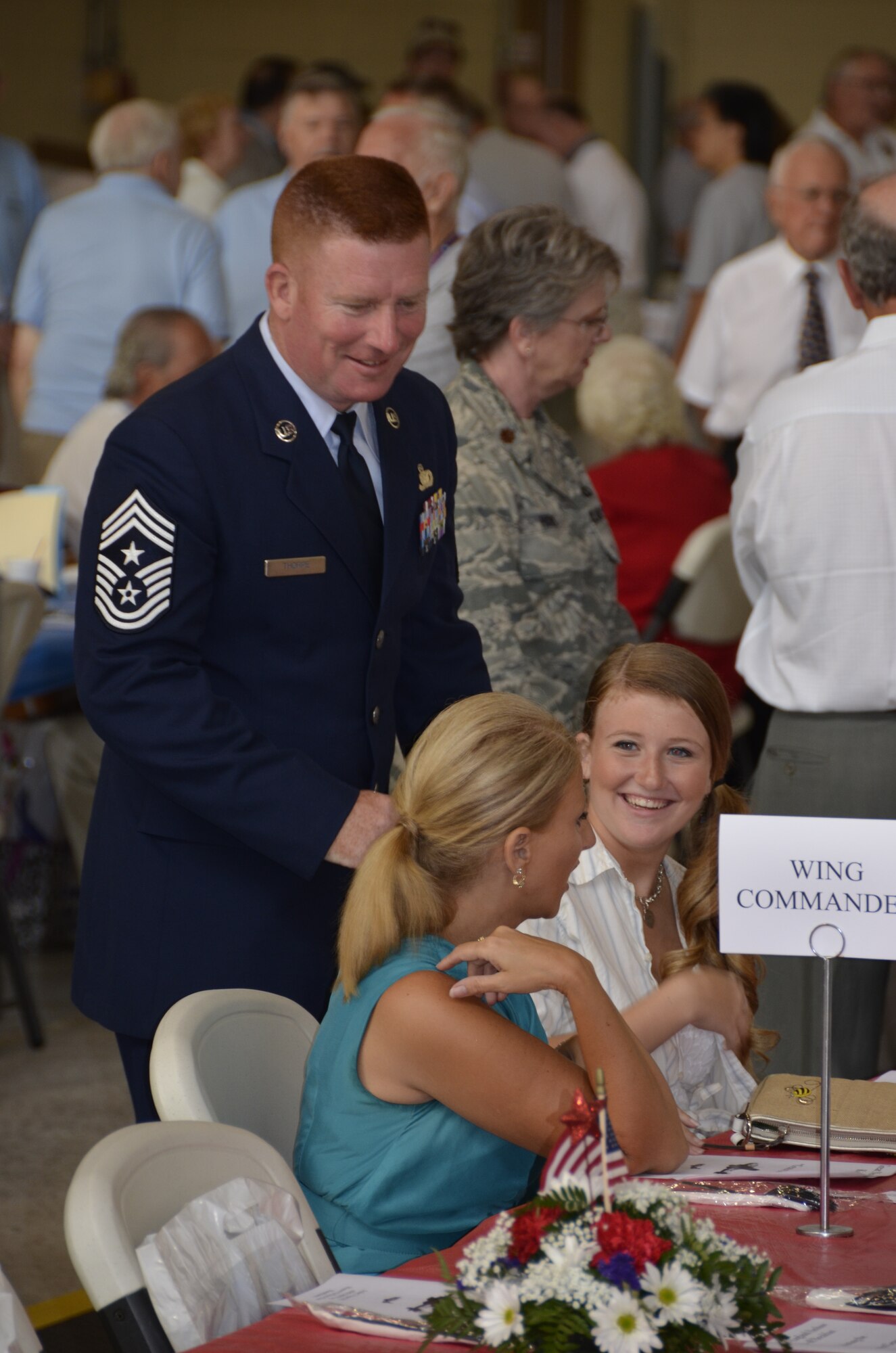 439th Airlift Wing Command Chief, CMSgt. Michael Thorpe, laughs with his family during the kick-off breakfast for the 2012 Great New England Air Show. (U.S. Air Force photo/SSgt. Kelly Goonan)