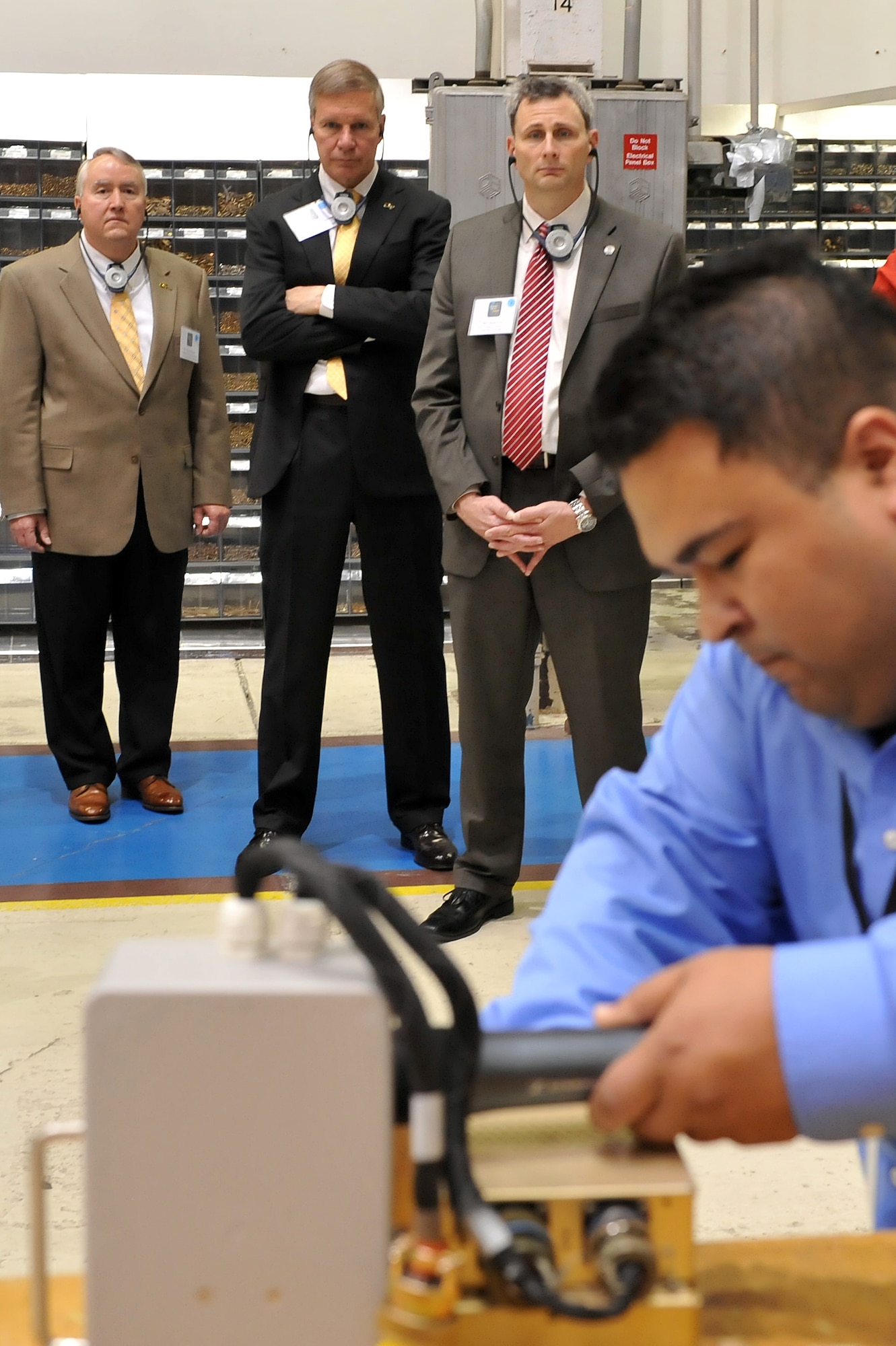 (Left)  Doug Nation, principal research engineer, Georgia Tech Research Institute; (Middle) Bud Peterson, president, Georgia Tech; (Right) Dr. Don Leo, dean, University of Georgia College of Engineering; observe as Jesse Gonzalez, electronics engineer, explains how work he does here helps keep the nation’s fighter and transport aircraft flying safely. (U.S. Air Force photo by Tommie Horton)   