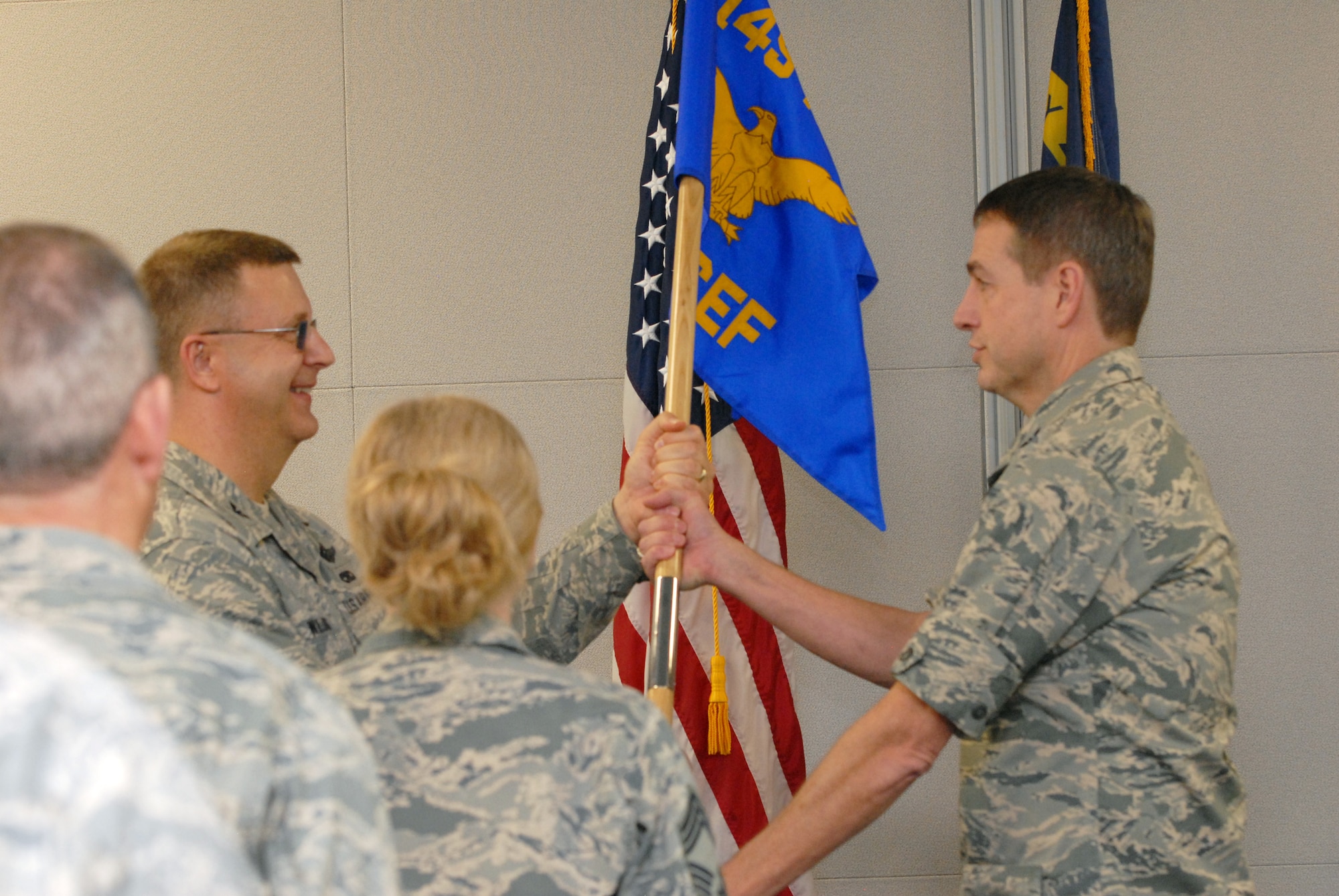 U.S. Air Force Col. Roger E. Williams Jr., 145th Airlift Wing commander, hands guidon over to Col. John Wolverton, as Wolverton assumes command of the 245th Civil Engineering Flight, during a Change of Command ceremony held at the North Carolina Air National Guard base, Charlotte-Douglas Intl. airport, Jan. 11, 2014. The traditional handing over of the guidon signifies the relief and acceptance of duty between two individuals from the base commander. It also allows for the accepting commander to be welcomed by troops, as well as the departing commander to give their ‘thank you’ and farewells. (Air National Guard photo by Senior Airman Laura Montgomery/Released)

